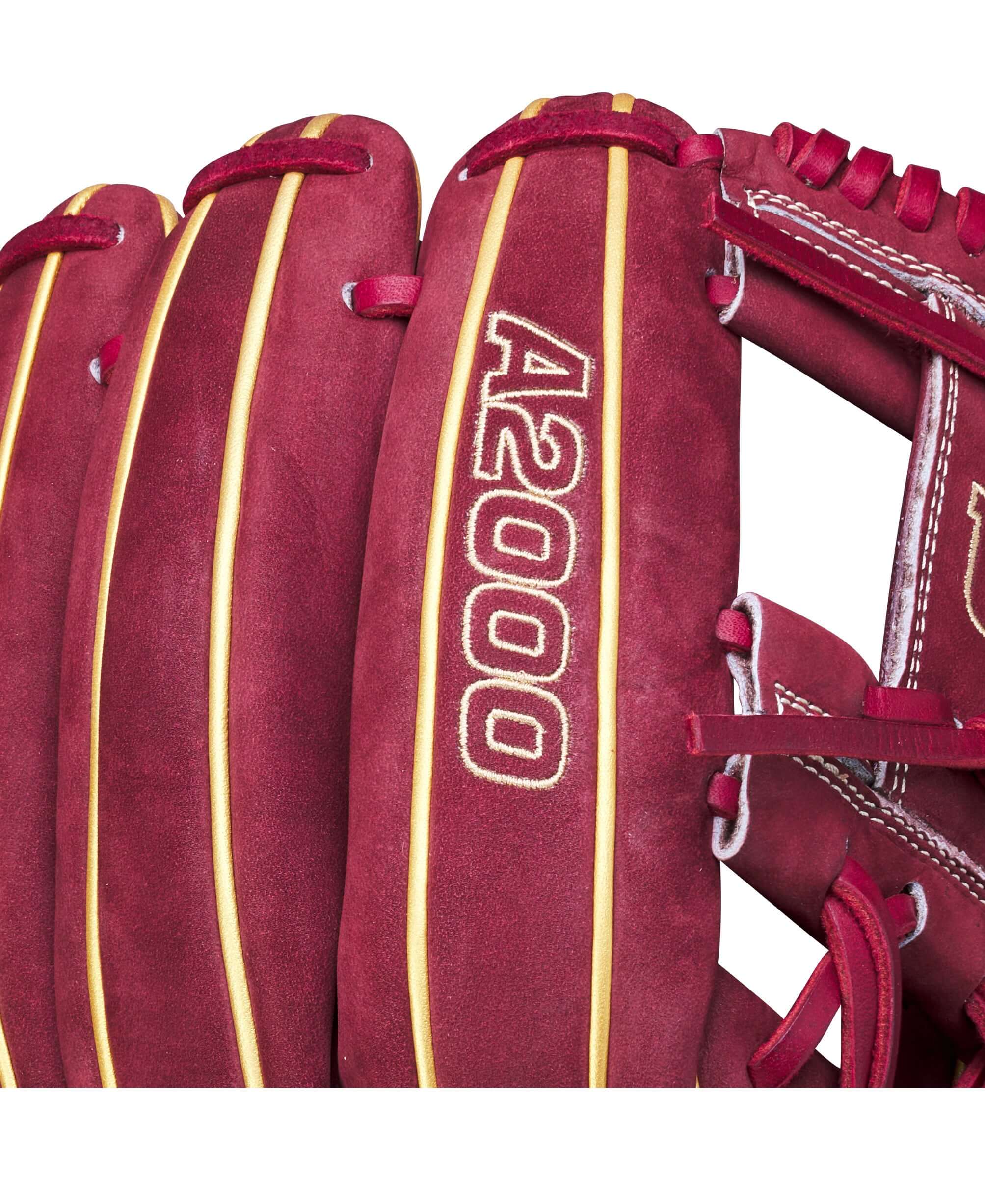 Close-up of Wilson A2000 glove with crimson velvet and metallic gold detailing, showcasing its premium craftsmanship.