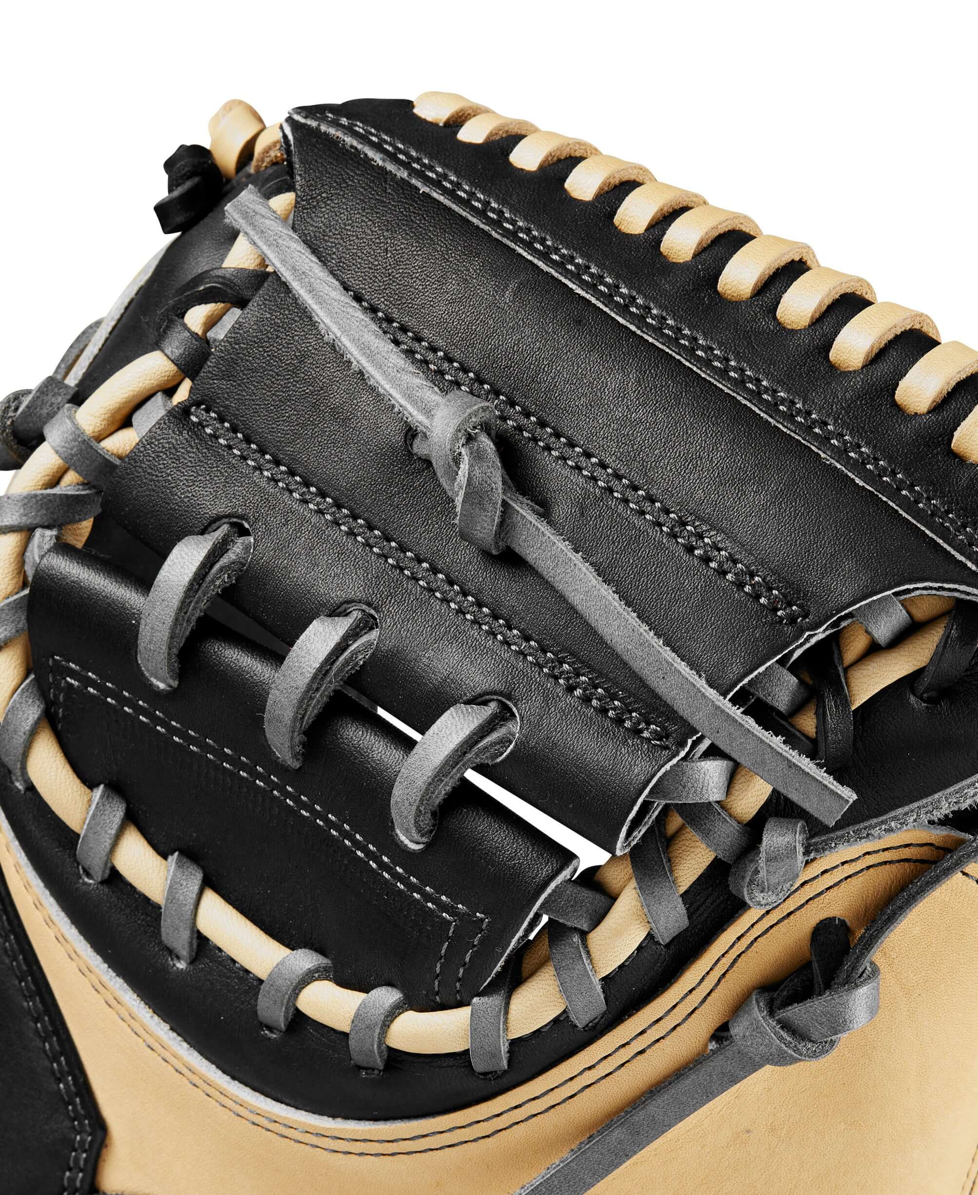 Close-up of the Wilson 2024 A2K M23 catcher's mitt featuring black and blonde leather, showcasing the intricate lacing details.