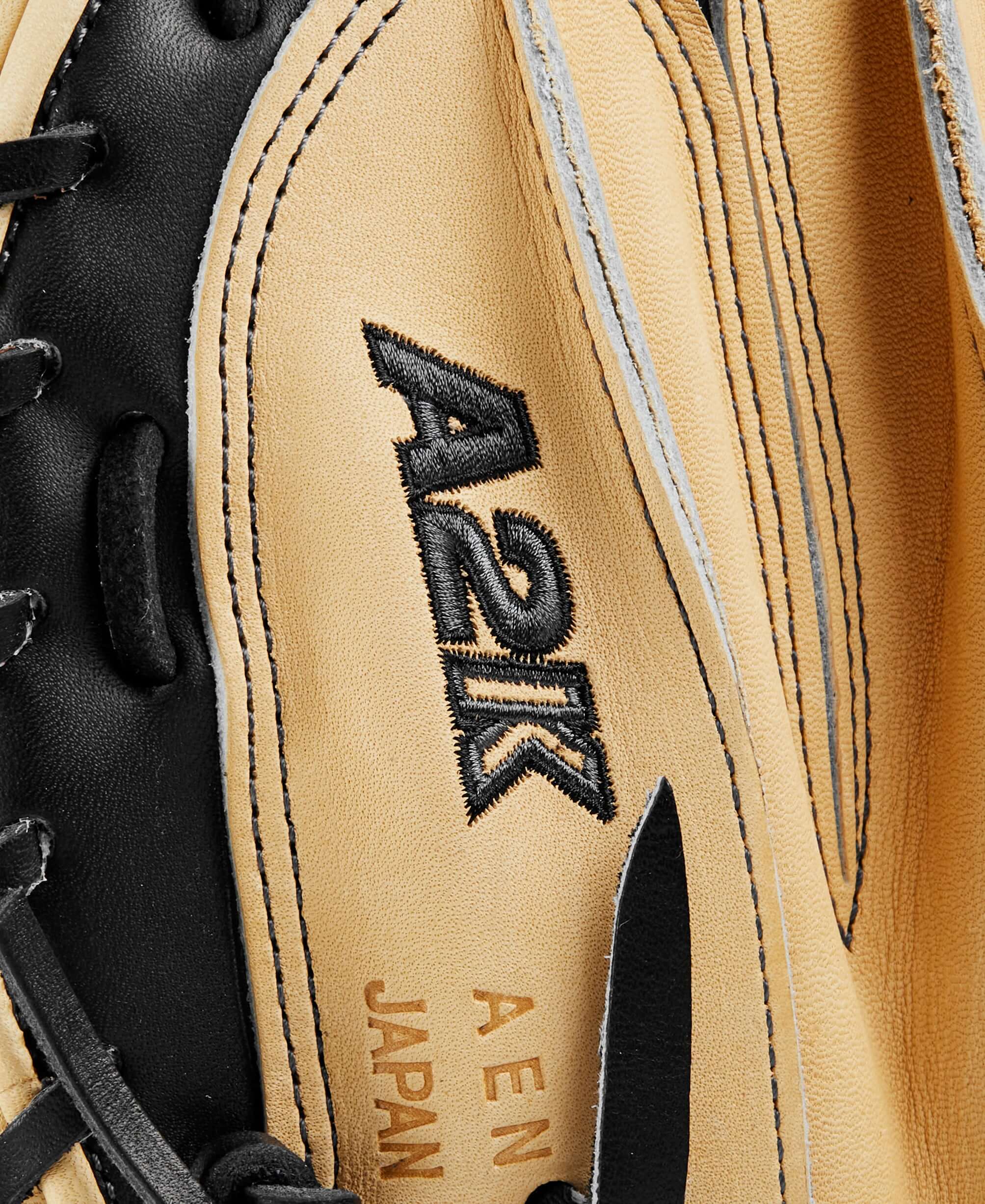 Close-up of the Wilson A2K catcher's mitt featuring black and blonde leather with detailed stitching and branding.