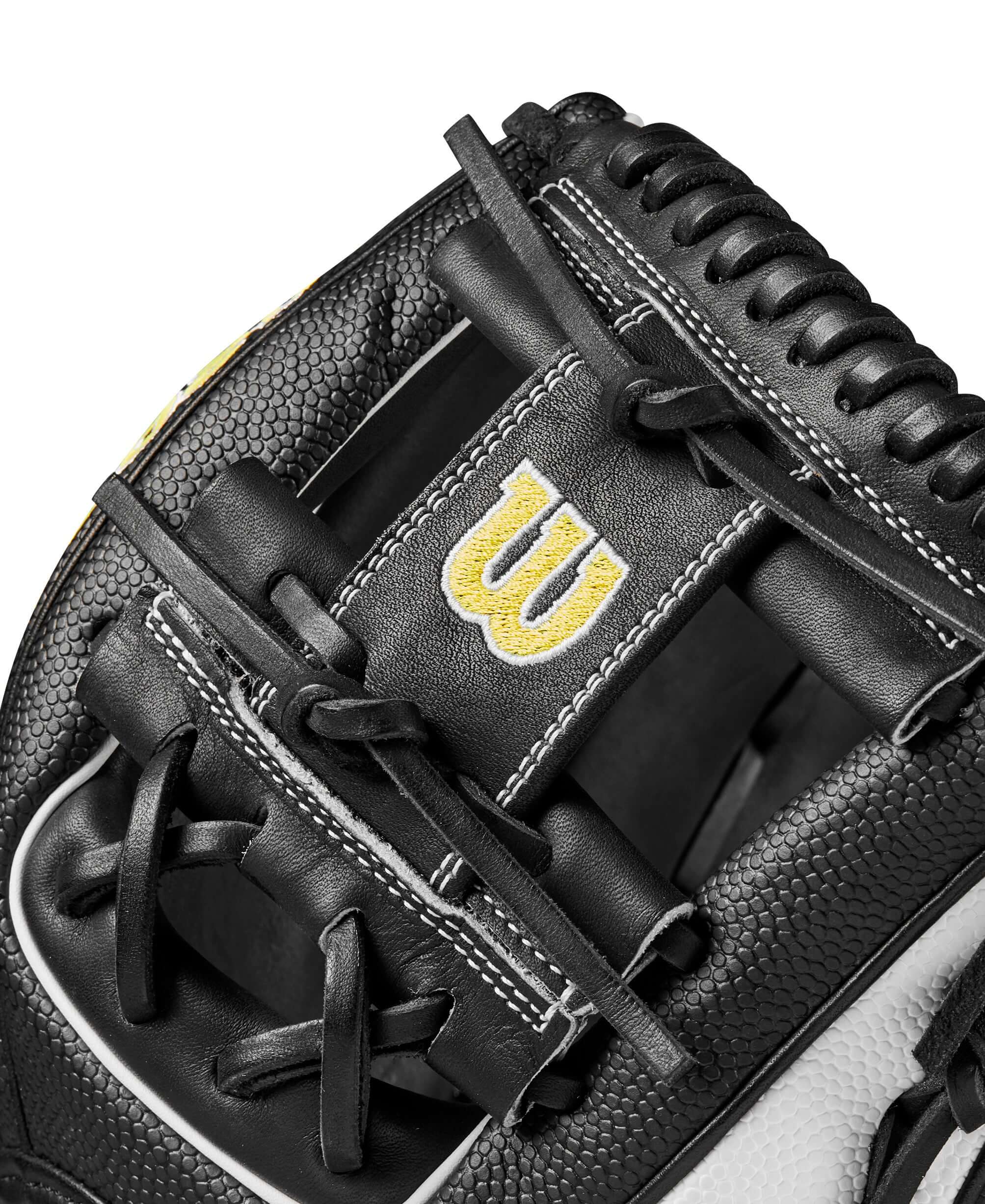 Close-up of the Wilson A2000 1786SS infield glove, showcasing black and white leather with yellow logo detail.