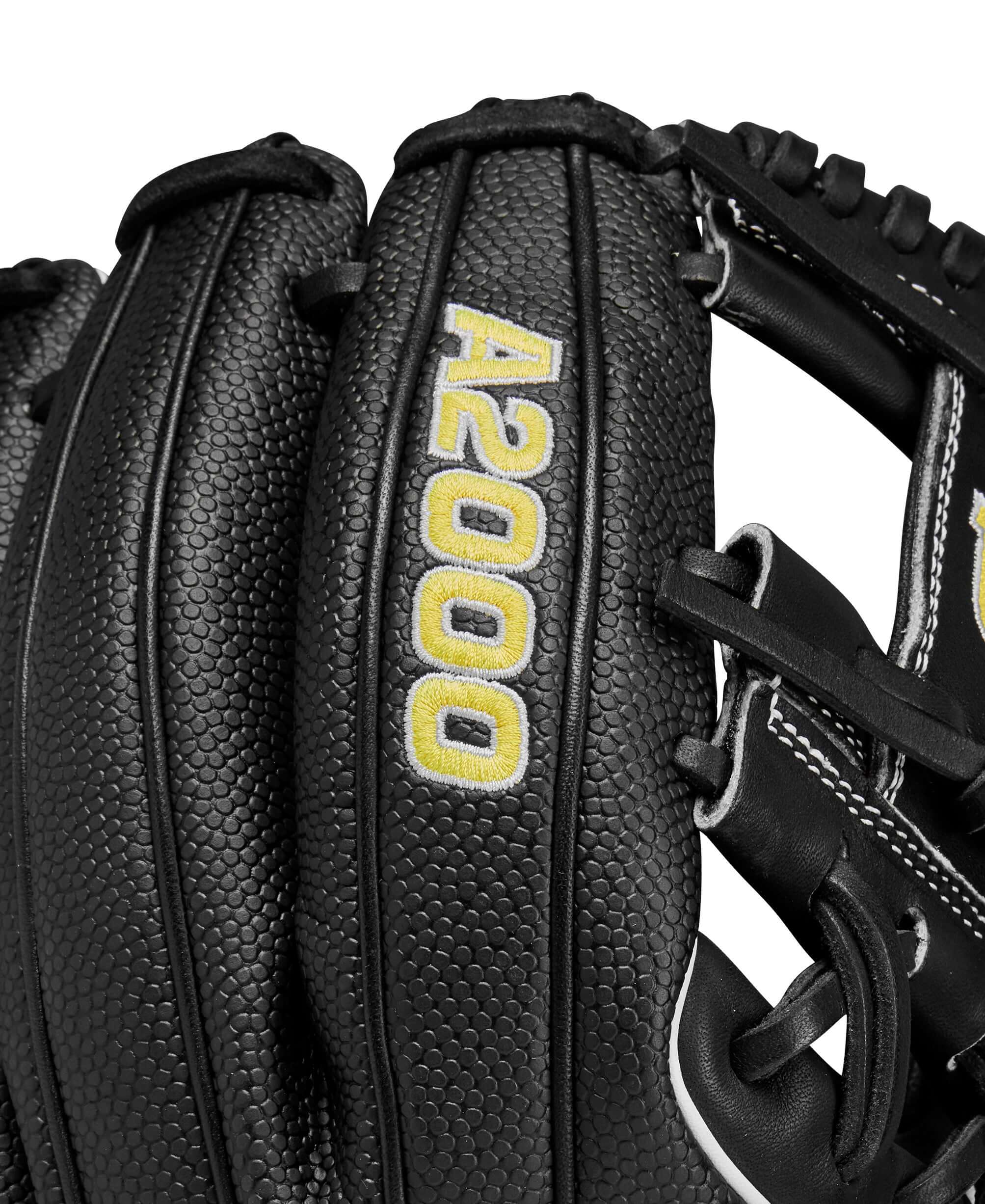 Close-up of Wilson A2000 glove showing black SuperSkin material and bold yellow lettering on the back.
