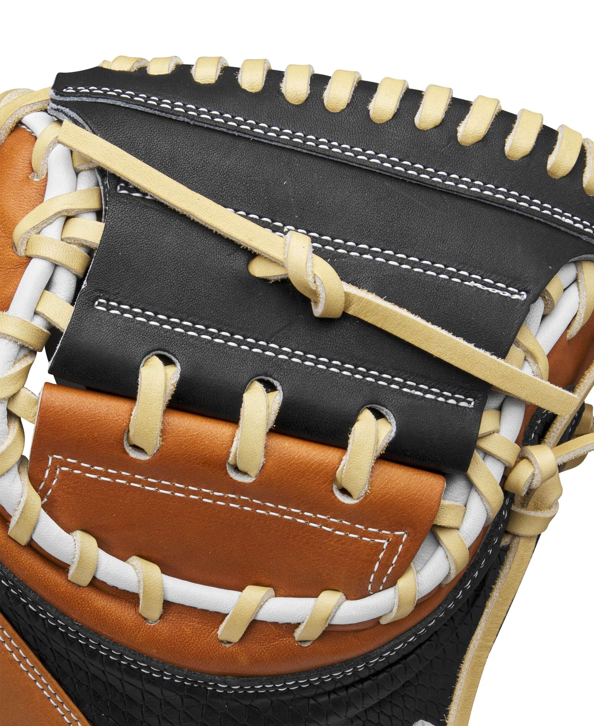 Close-up of Wilson A2000 M23 Catcher's Mitt showing intricate stitching and leather patterns in black, blonde, and saddle tan.