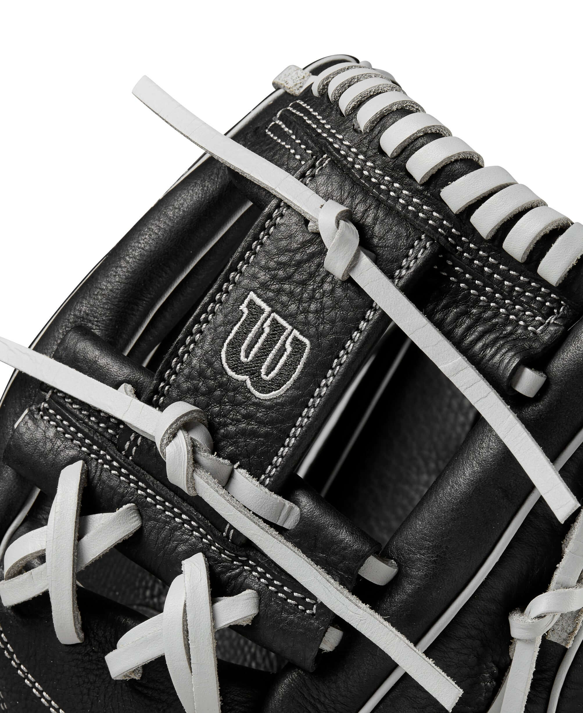 Close-up of Wilson A1000 H75 softball glove featuring black full grain leather and white lacing details.