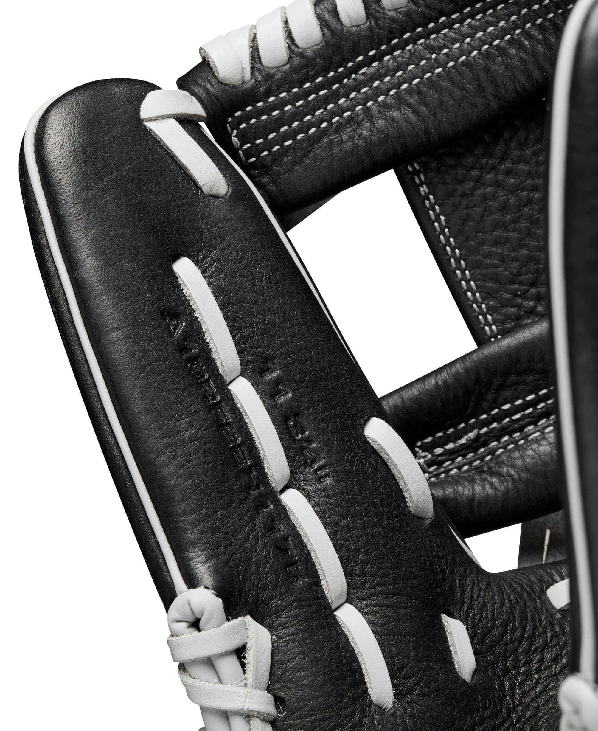 Close-up of Wilson 2024 A1000 H75 infield softball glove, showcasing black leather and white stitching details.