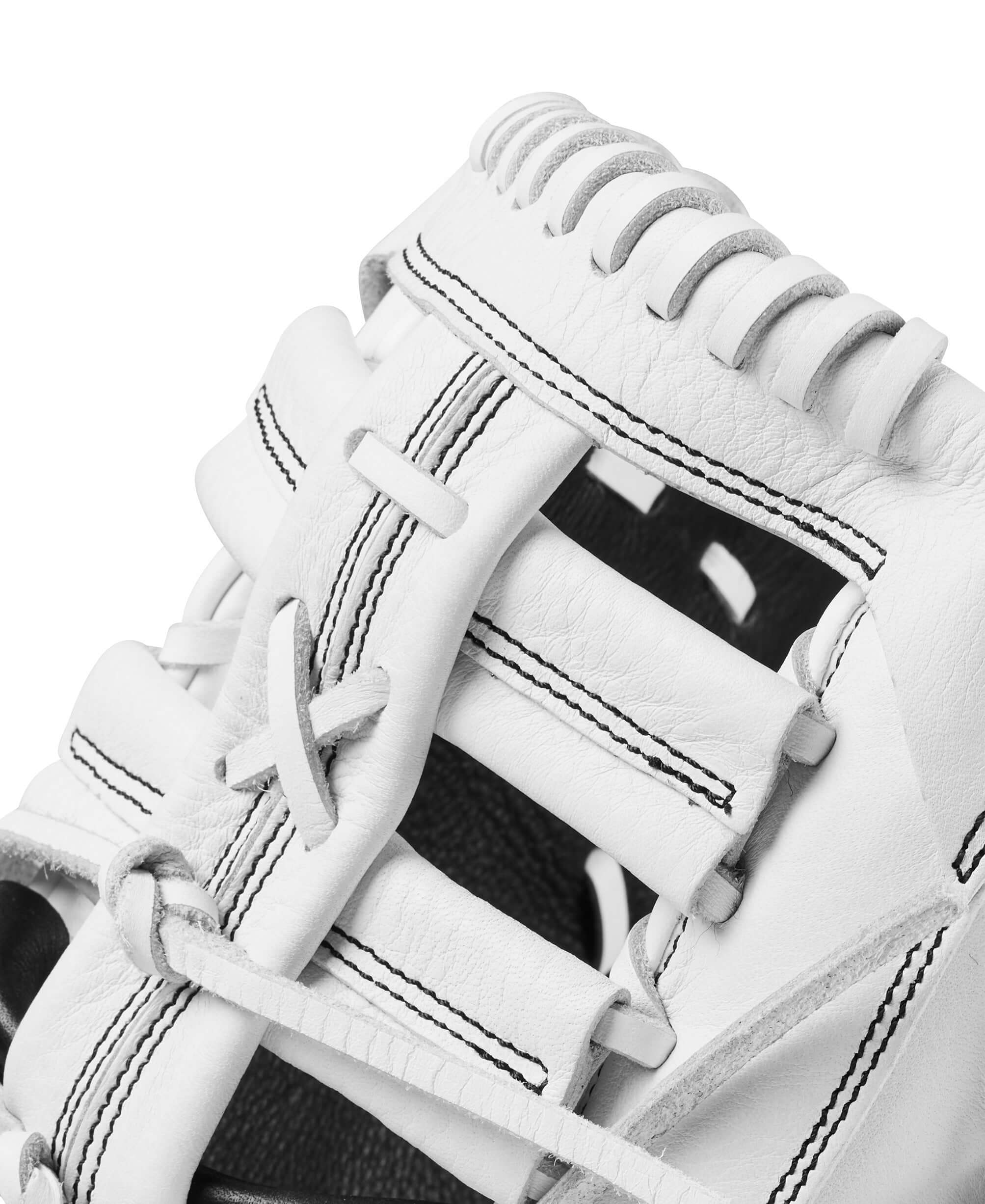 Close-up of the Wilson 2024 A1000 1620 first base mitt showing the webbing and leather details in white.