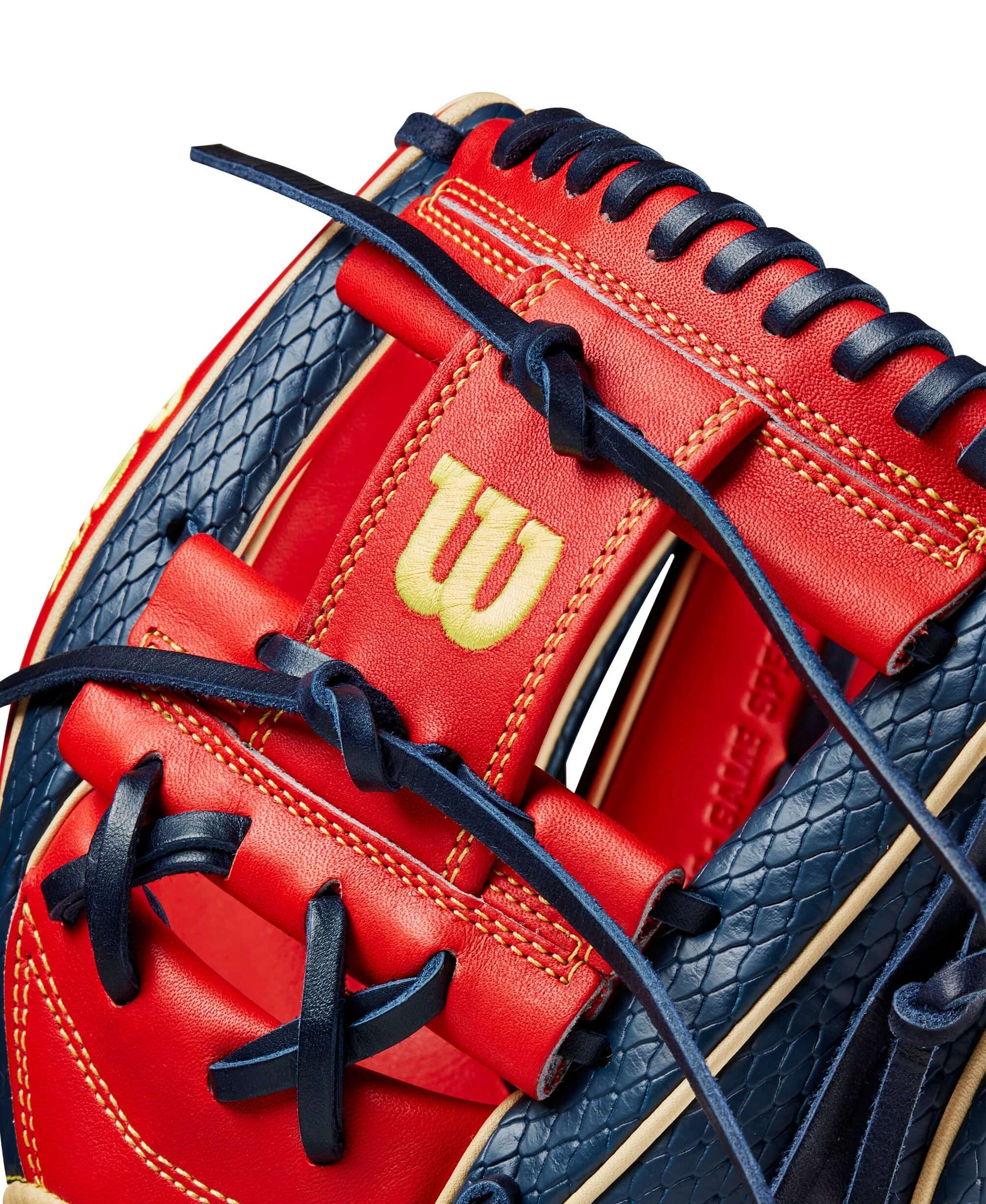 Close-up of Wilson 2024 A2K Ozzie Albies glove showcasing navy blue and red design and intricate lacing details.