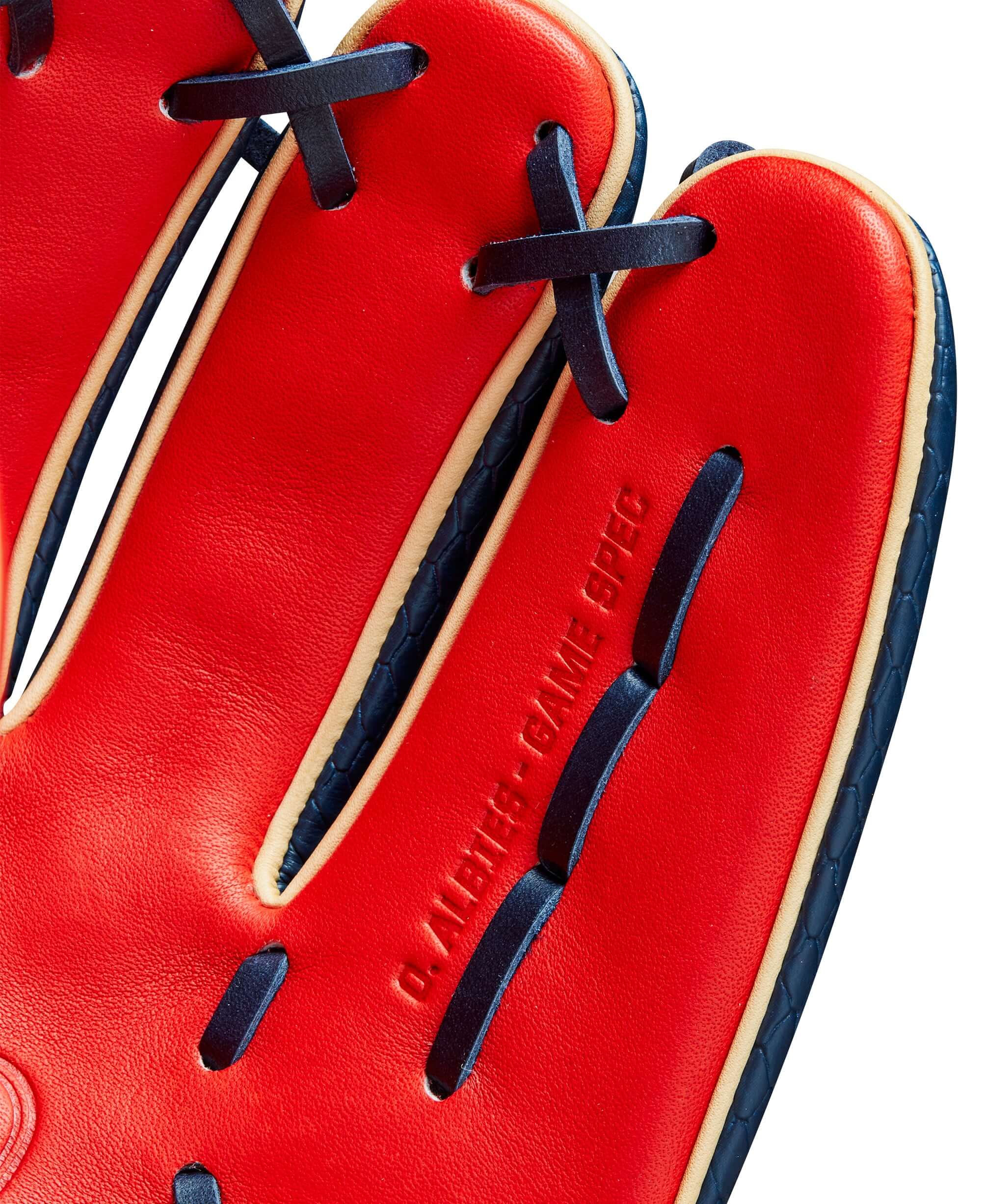 Close-up of Wilson 2024 A2K Ozzie Albies Game Model glove interior, featuring red leather and navy blue lacing details.