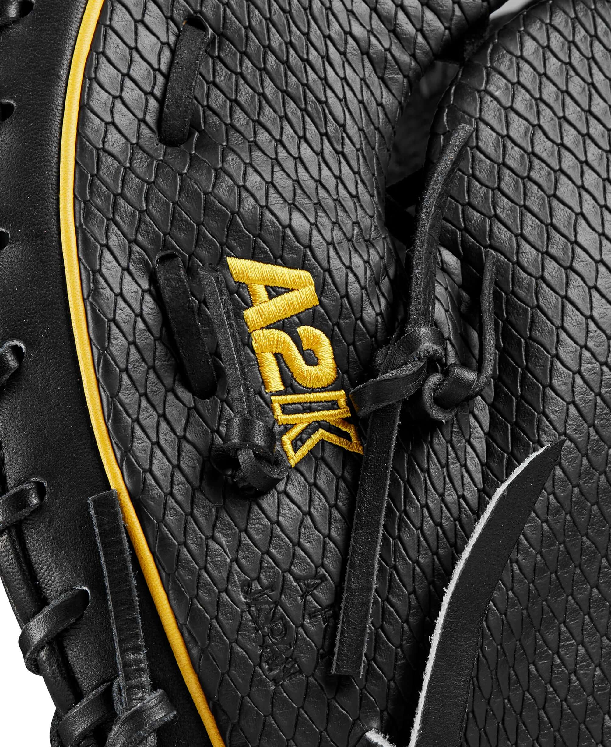 Close-up of Wilson A2K first base mitt showing black leather texture and yellow A2K logo detail.