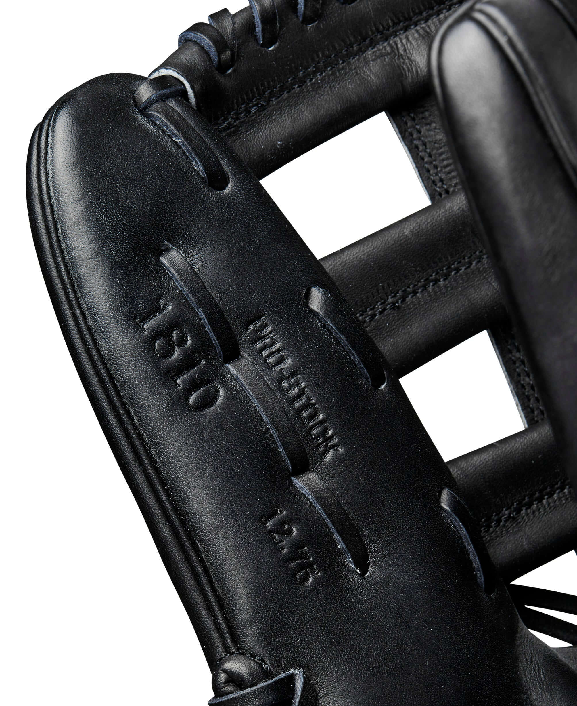 Close-up of Wilson A2000 1810 outfield glove showing Pro Stock leather and size details, ideal for baseball players.