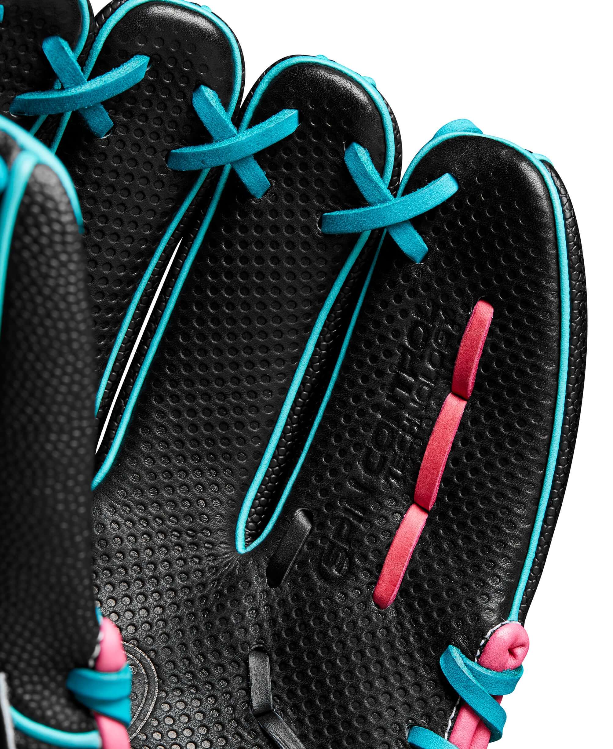 Close-up of the Wilson A2000 glove, showcasing the black leather palm with teal and pink details and Spin Control Technology.