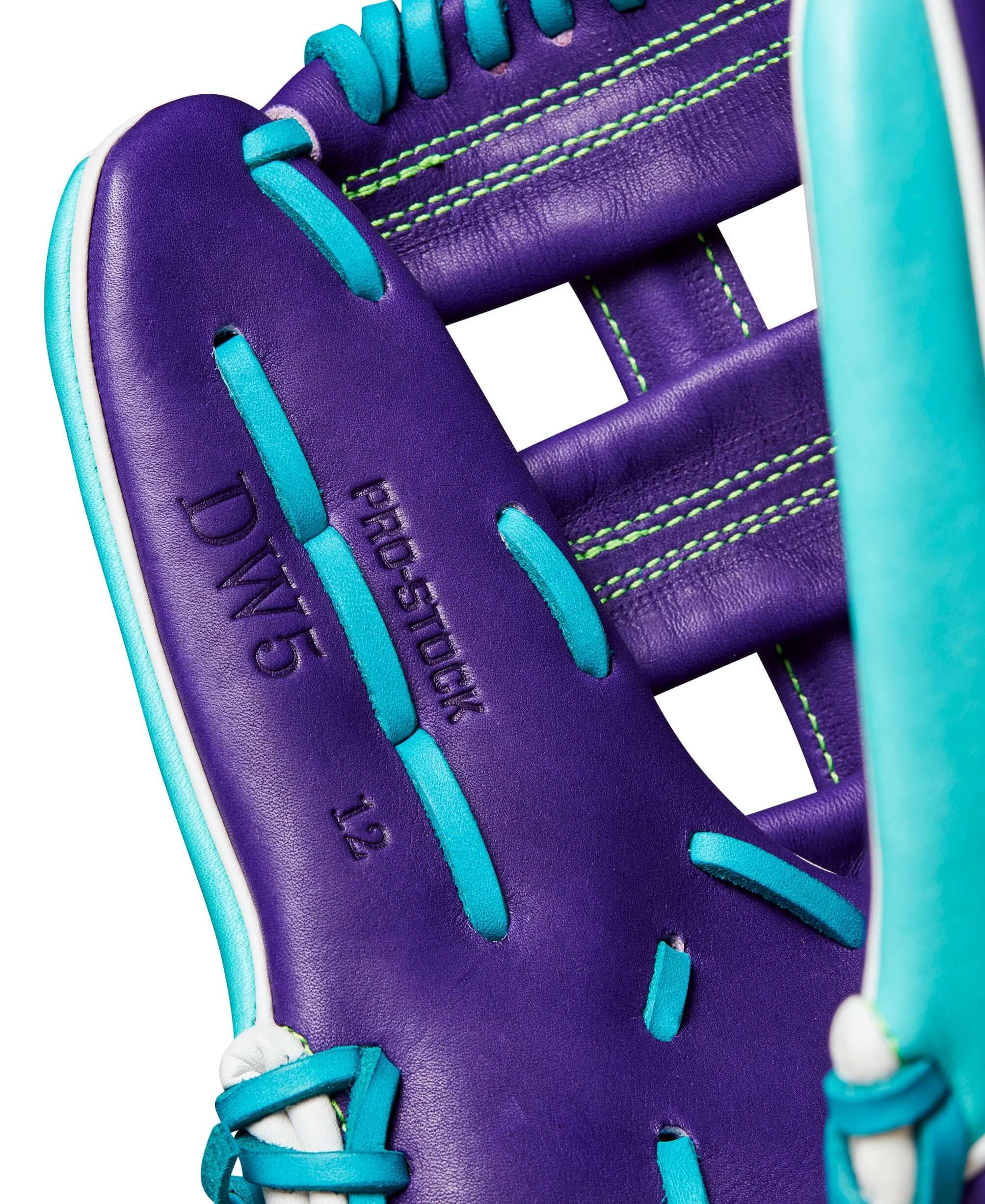 Close-up of Wilson A2000 DW5 glove showing teal and purple leather with Pro Stock branding, designed for infield performance.