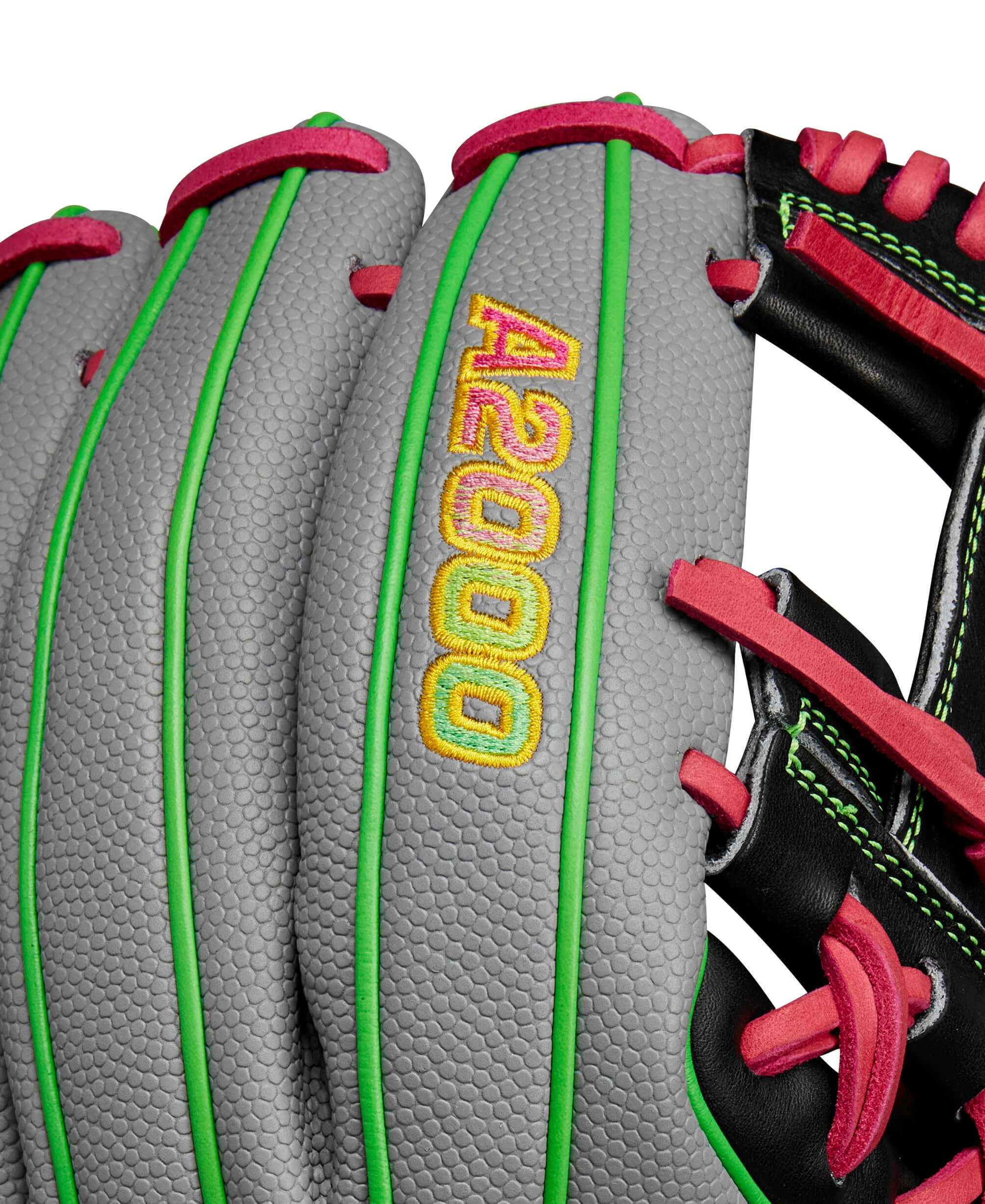 Close-up of Wilson A2000 1786 glove showcasing splatter design and bright Neon Green and Flamingo Pink accents.