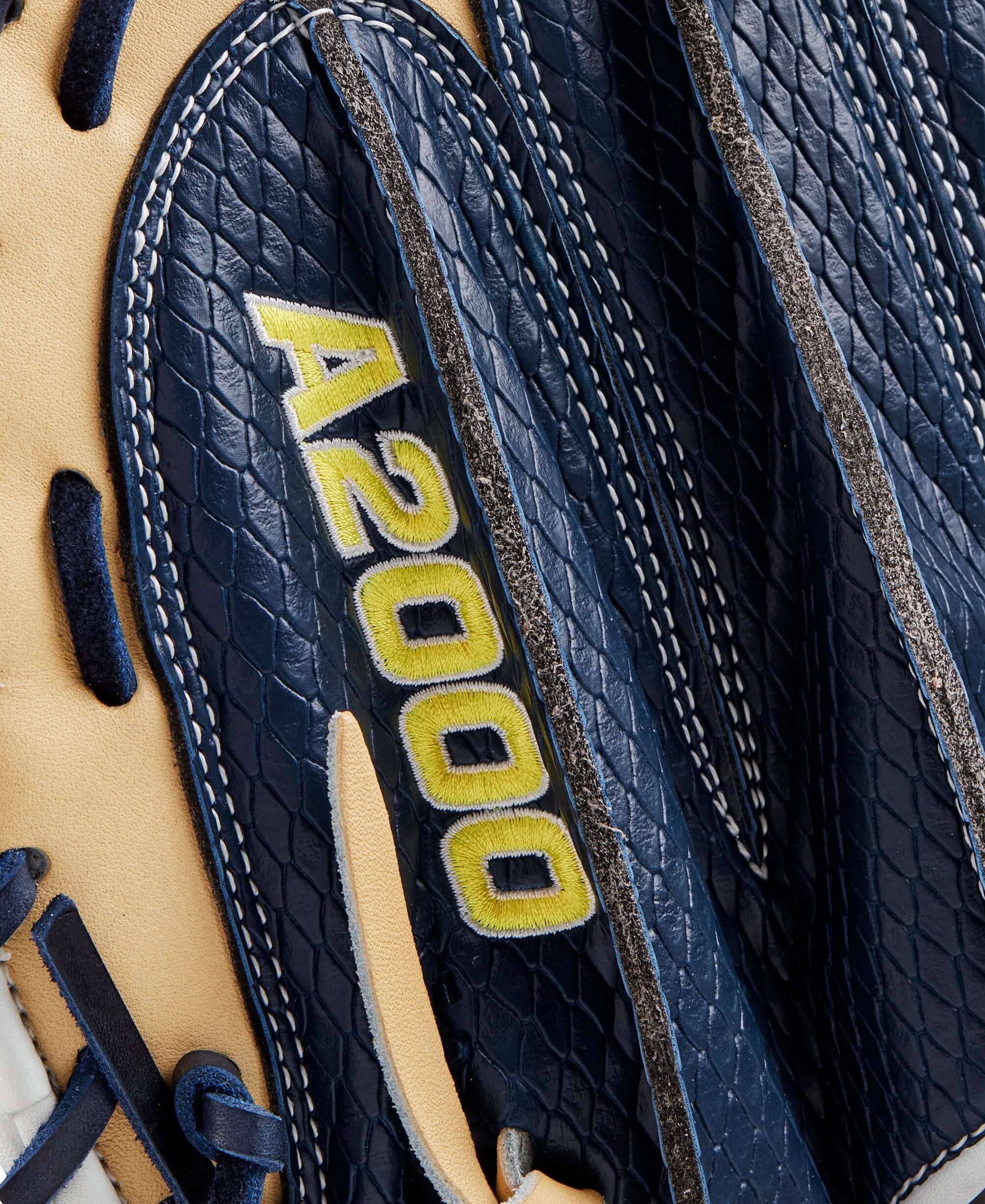 Close-up of Wilson A2000 Winter 2024 Catcher's Mitt in navy and blonde, showcasing premium leather details.