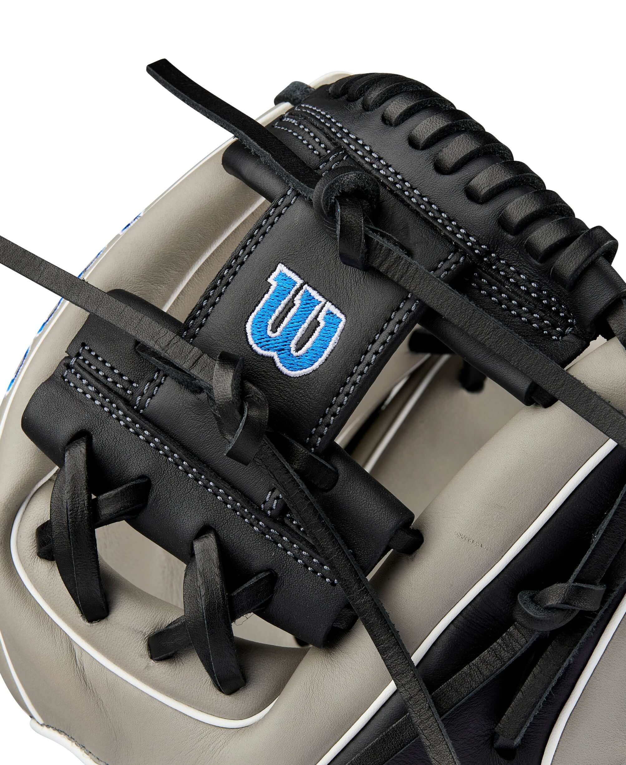 Close-up view of the Wilson A900 PF1125 baseball glove showcasing its black leather and blue logo detail.