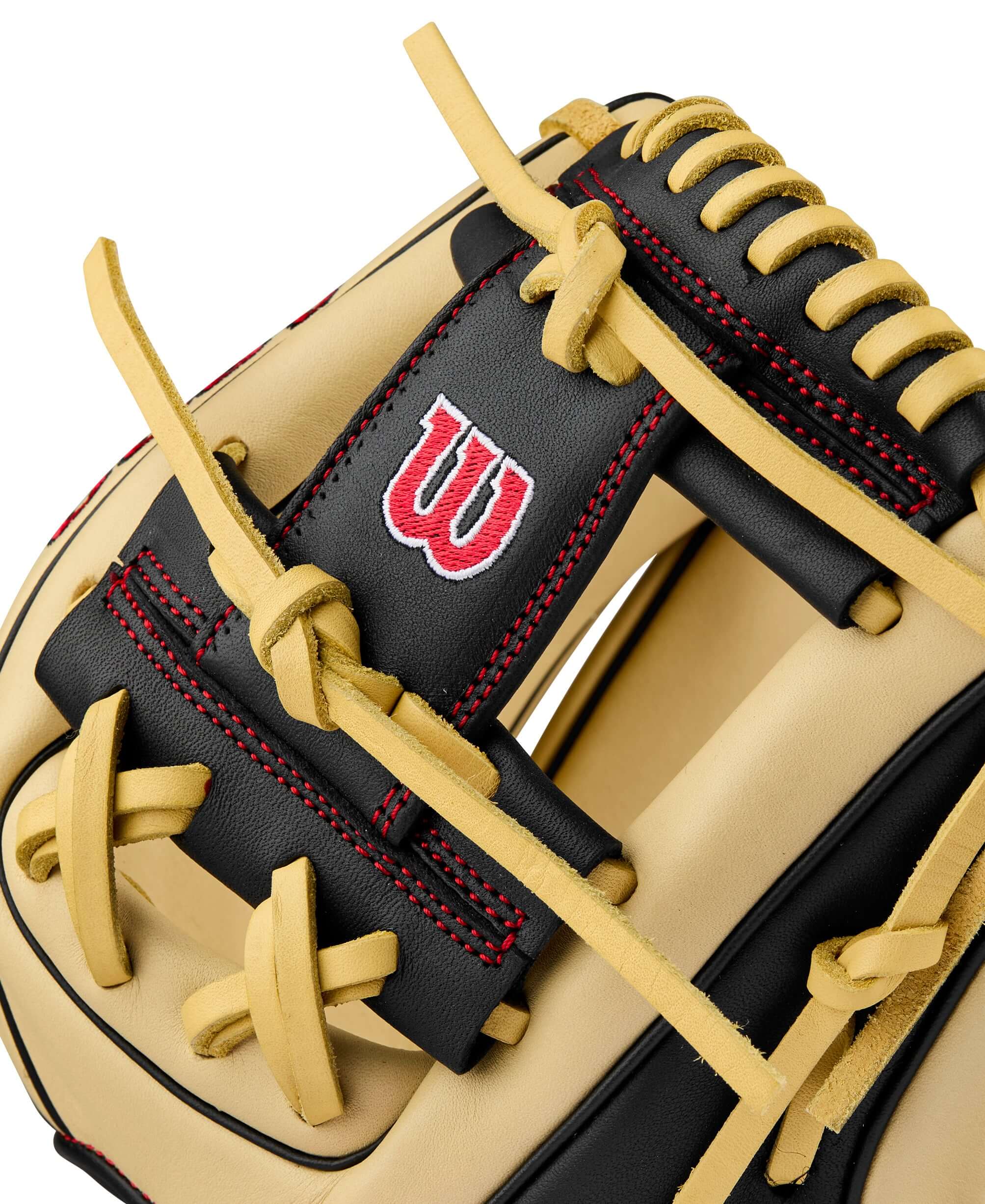 Close-up of BTL Wilson A900 PF115 glove featuring Blonde and Black leather, with red stitching and logo, perfect for youth players.