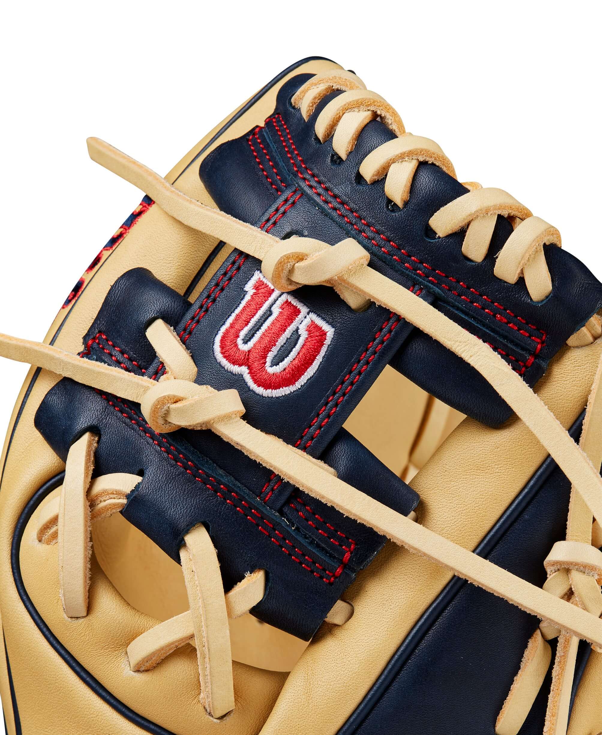 Close-up of BTL Wilson A1000® PF11 glove showing blonde leather, navy accents, and intricate lacing detail for young infielders.