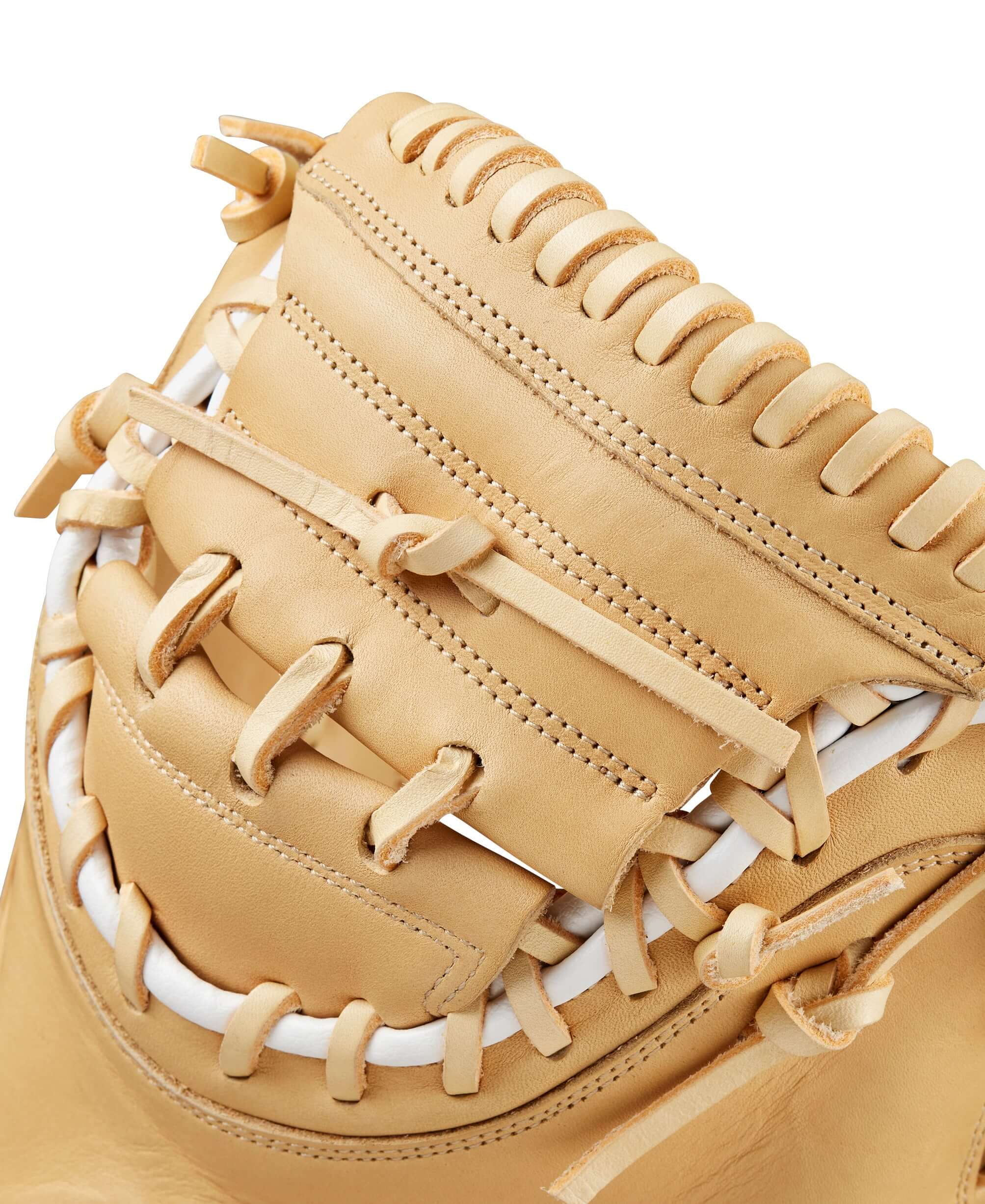 Close-up of the BTL Wilson A1000® CM33 33” baseball catcher's mitt showcasing the Blonde Full Grain leather and intricate stitching.