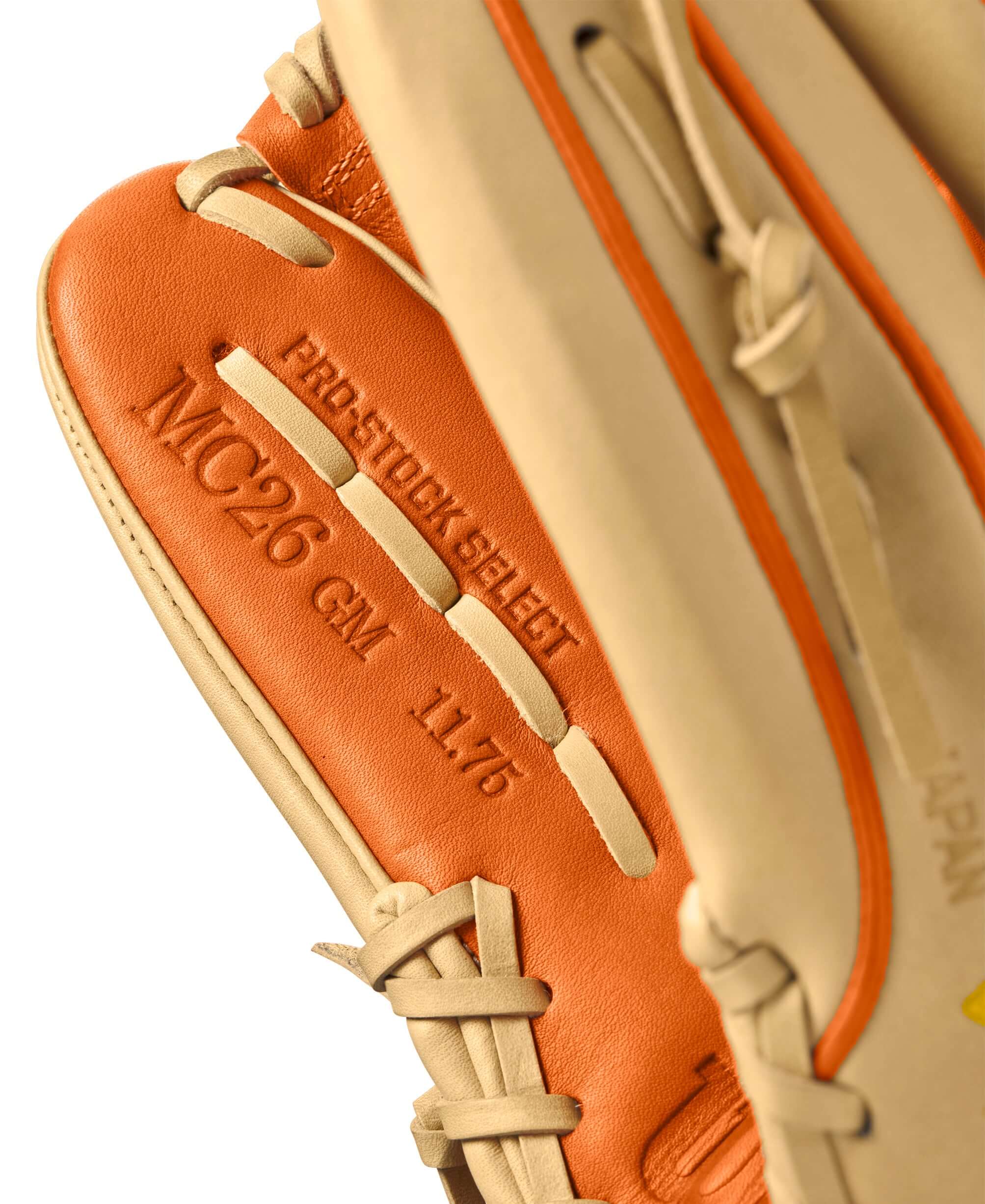 Close-up of the Wilson A2K MC26 glove label featuring Pro Stock Select leather in blonde and orange tan colors.