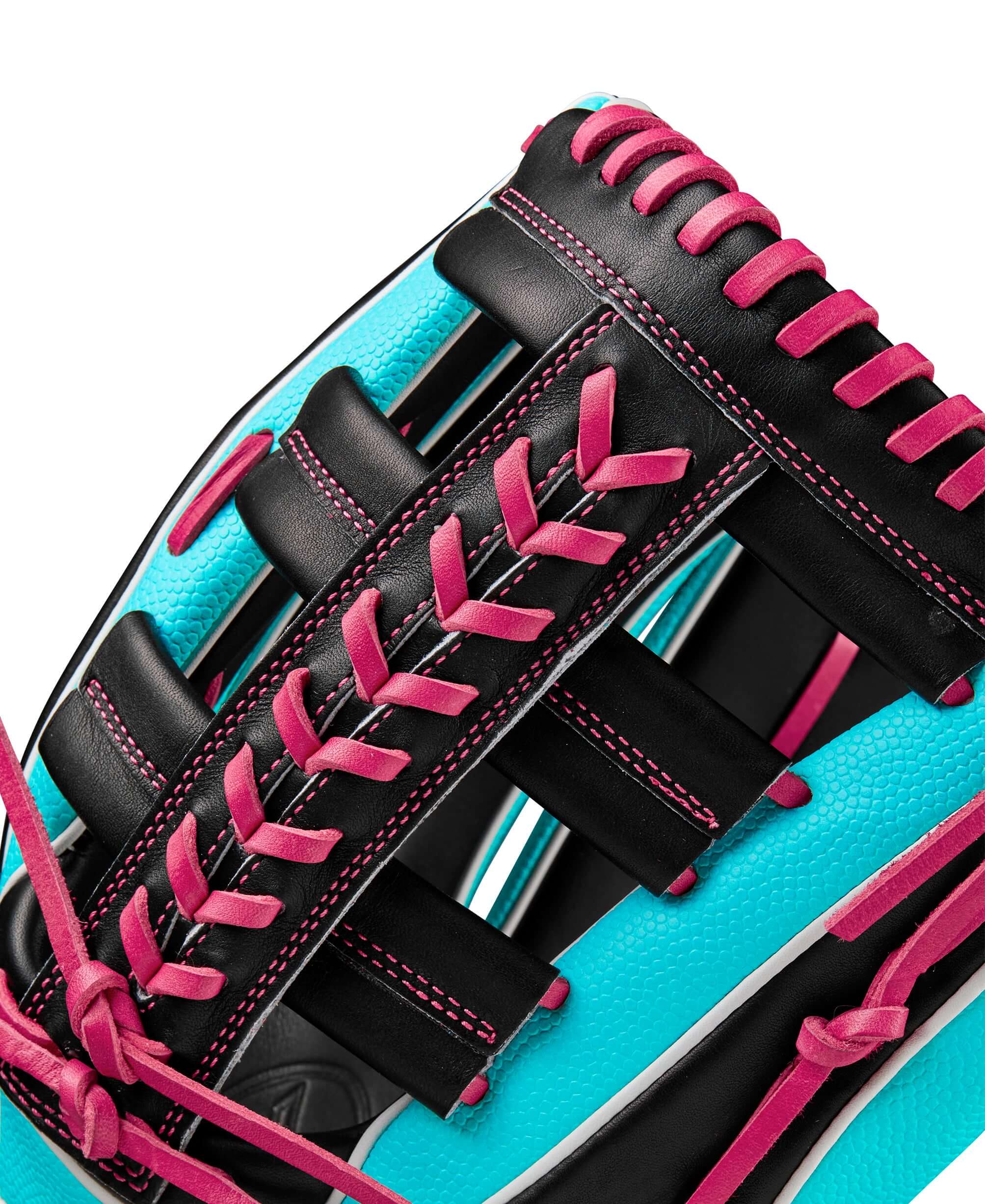 Close-up of the Wilson A2K 1810SS glove showcasing teal and black leather with pink stitching details and Single Post Web design.