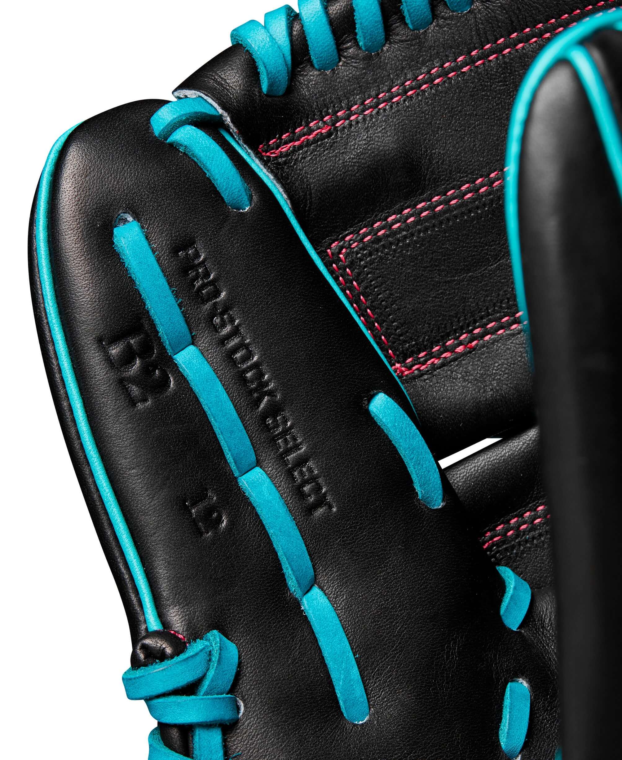 Close-up of Wilson A2000 B2 pitcher's glove featuring black leather with teal accents and Pro Stock Select branding.