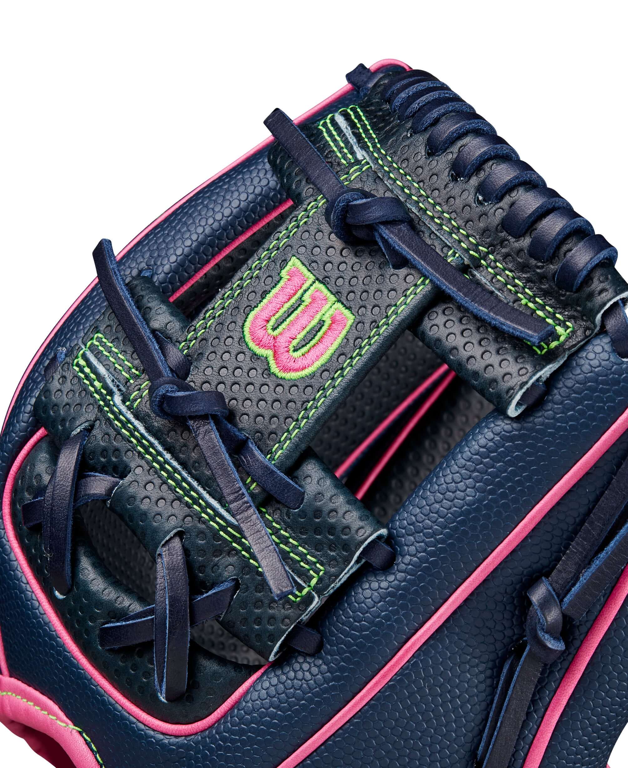Close-up of Wilson A2000 DP15SS glove in navy, pink, and green with Pedroia Fit Technology for infielders.