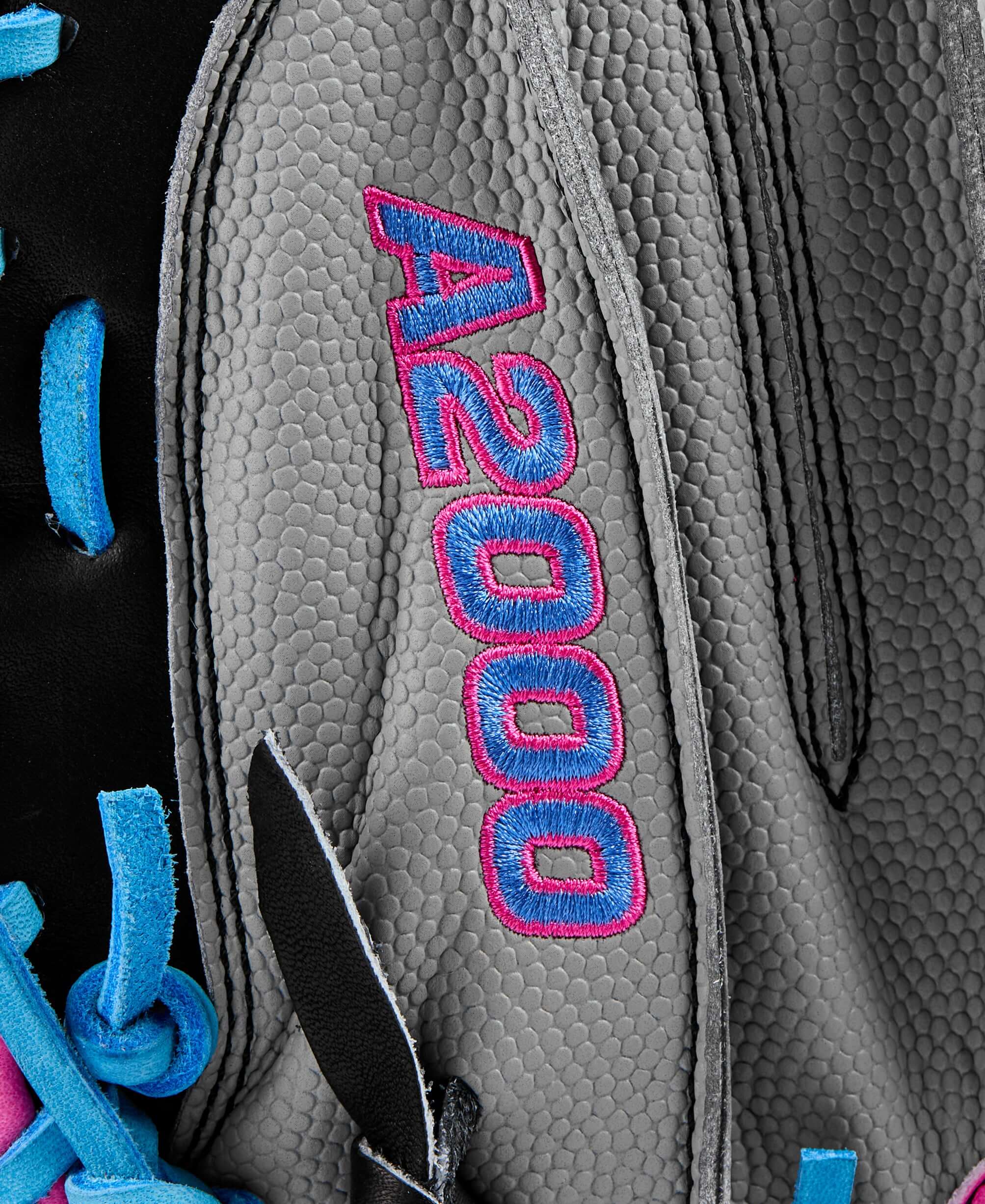 Close-up of the Wilson A2000 logo on a catcher’s mitt showcasing vibrant colors and textured leather.