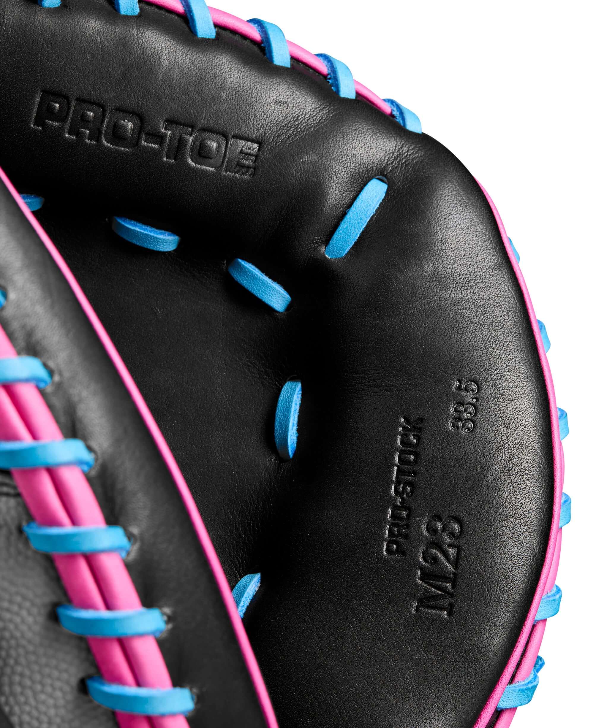 Close-up of Wilson A2000 M23CMSS mitt, featuring Pro Stock leather and vibrant blue and pink stitching, size 33.5 inches.