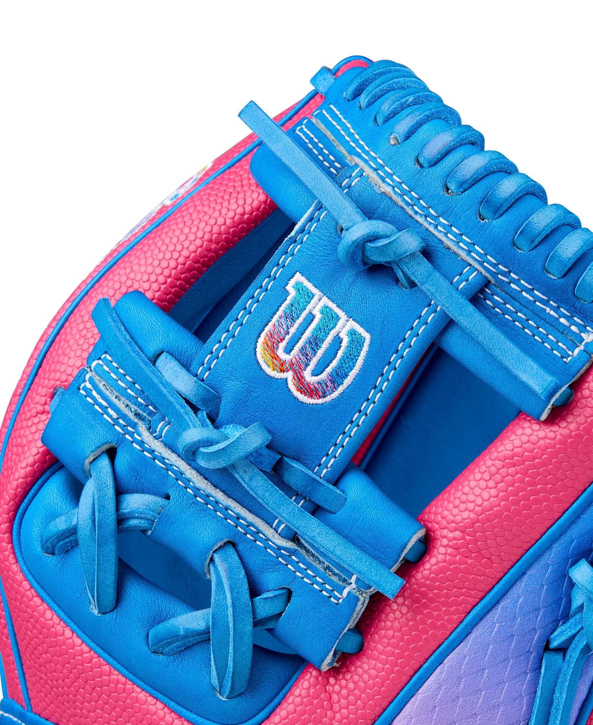 Close-up of the Wilson 2025 A2000 1786SS baseball glove showcasing vibrant blue and pink design details.