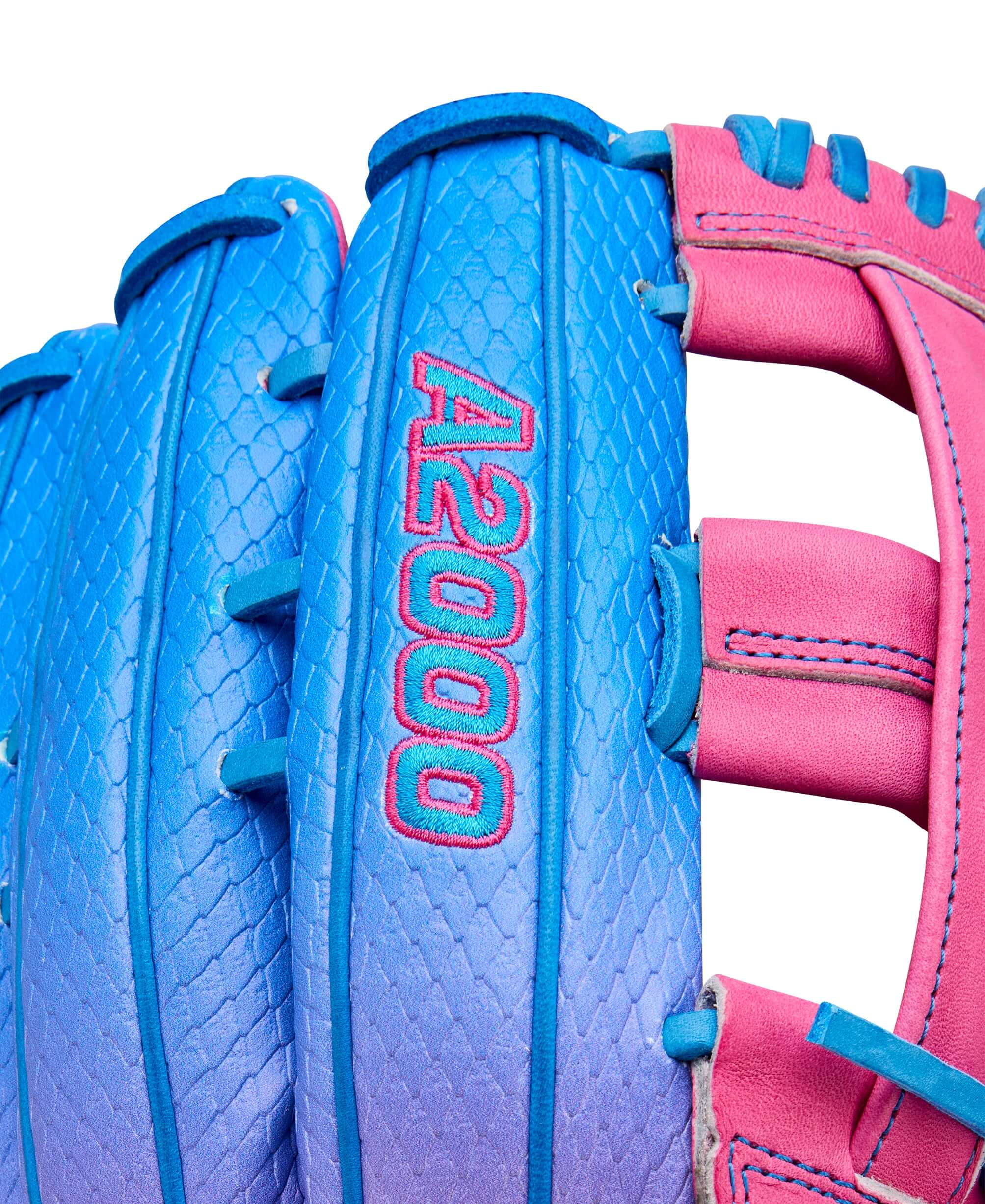 Close-up of the Wilson A2000 1777SS outfield baseball glove in pink and blue colors with detailed stitching.