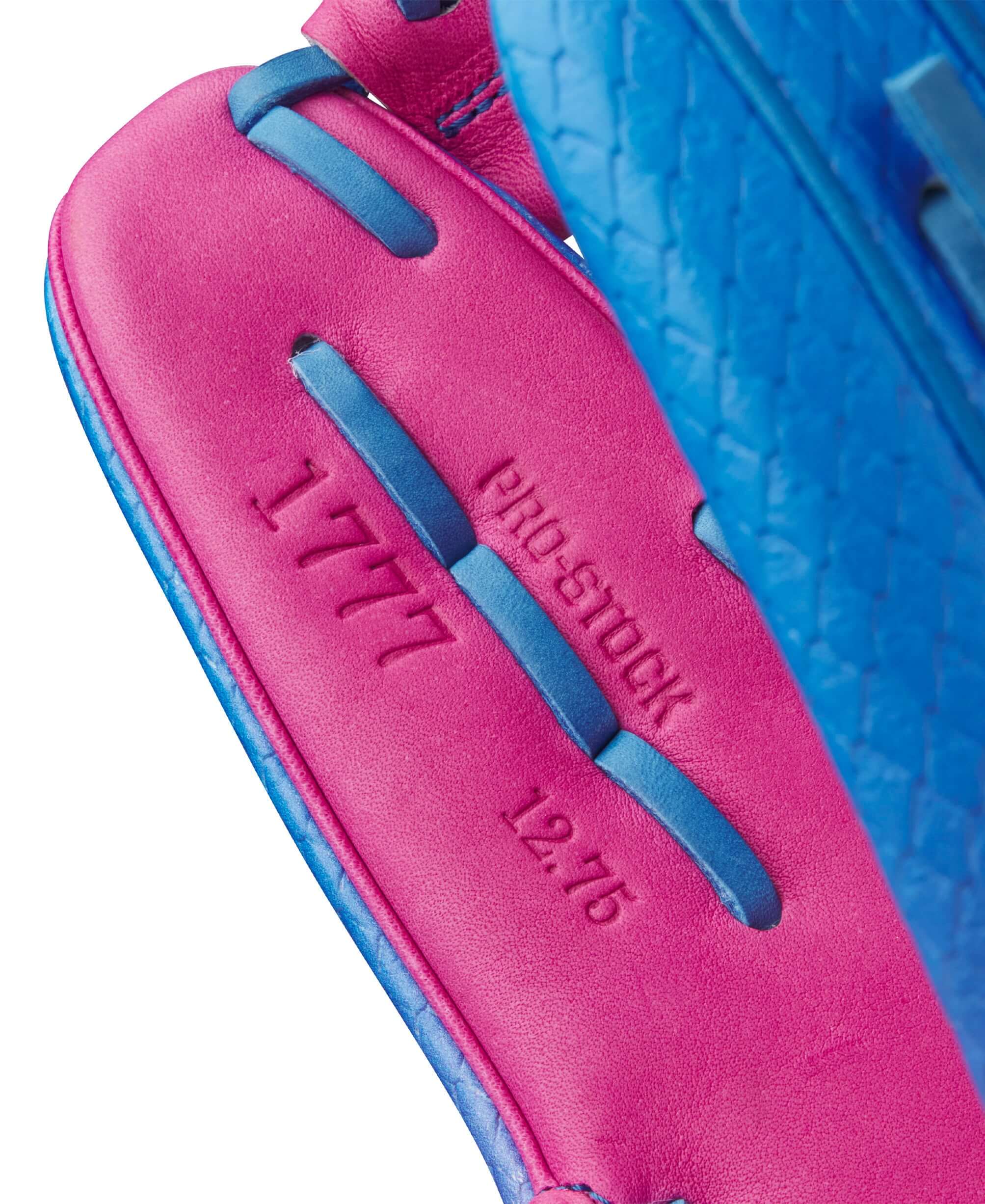Close-up of Wilson A2000 1777SS glove showing pink Pro Stock leather with model number and size detail.