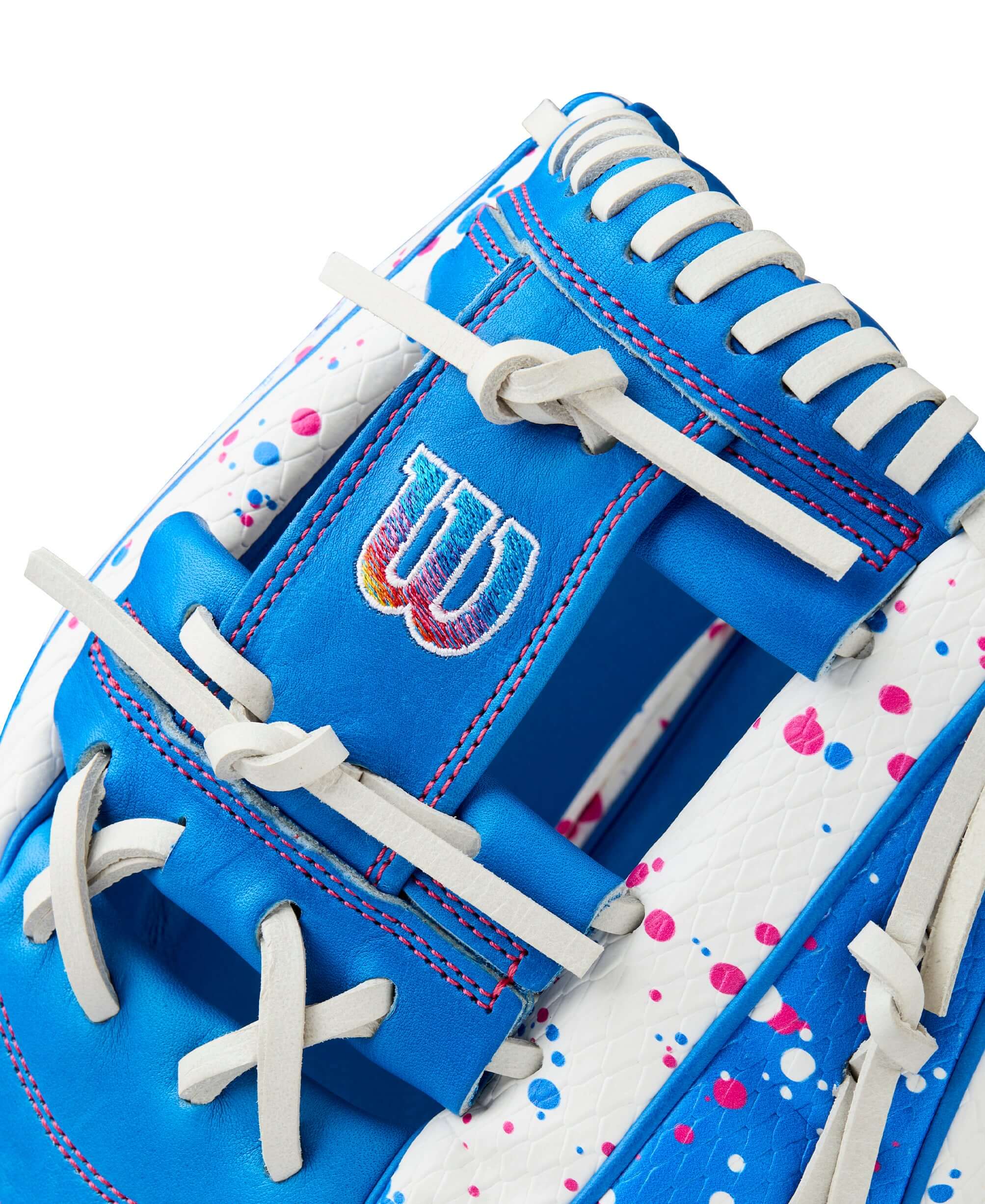 Close-up of Wilson A2000 H12SS glove showcasing blue and pink splatter design and lace details.