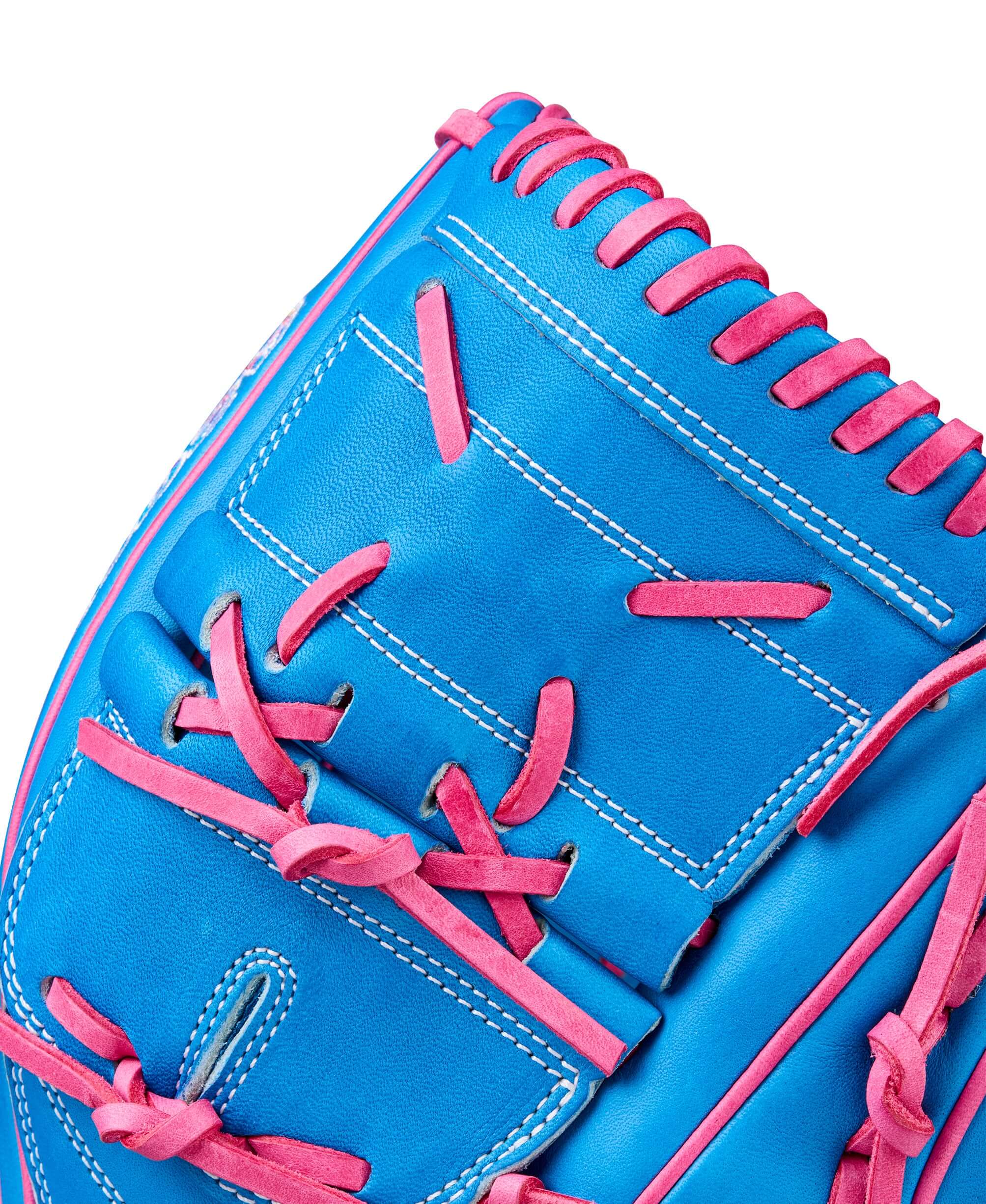 Close-up of Wilson 2025 Love the Moment A2000 B2 pitcher's glove in blue leather with pink accents.