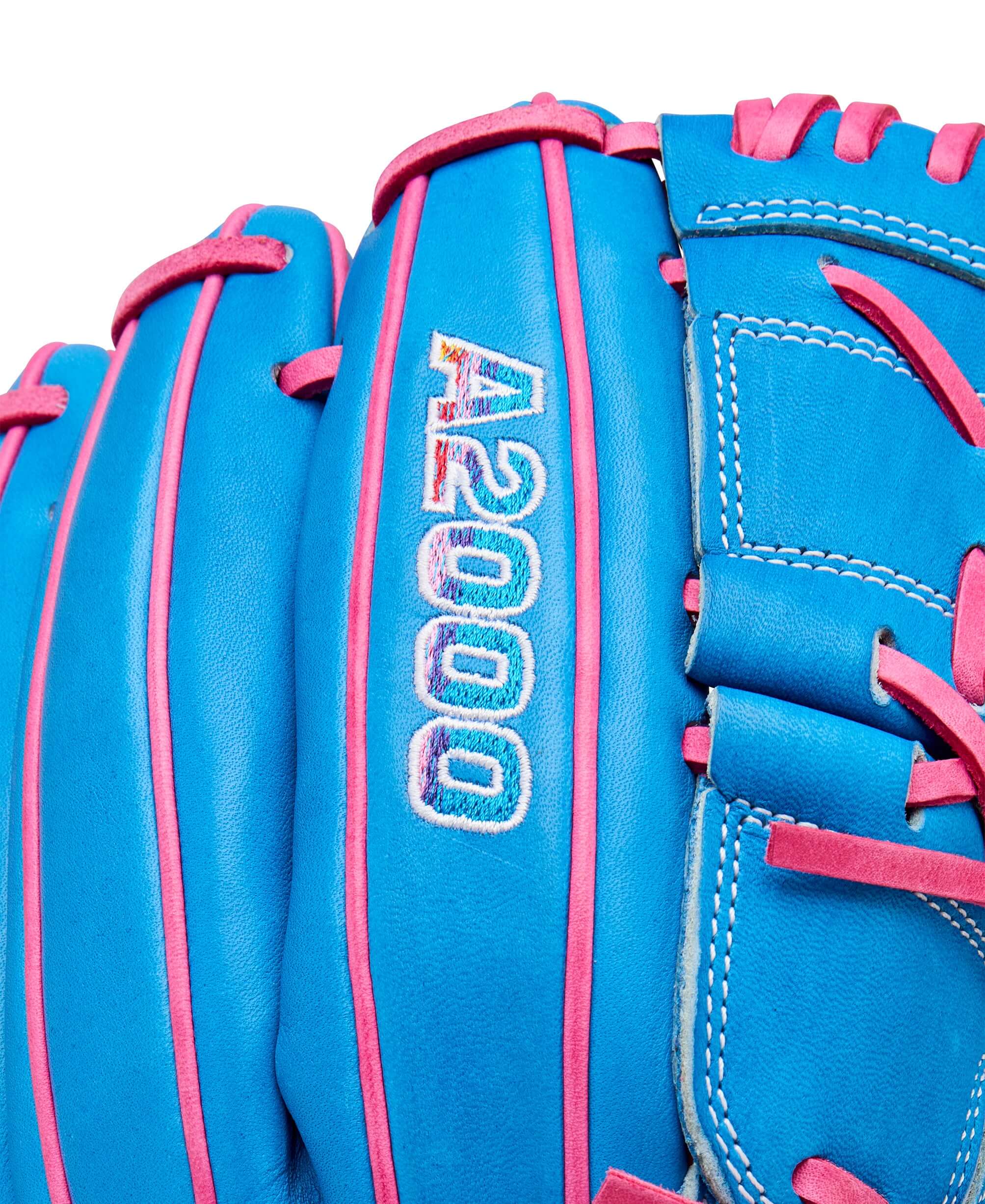 Close-up of Wilson A2000 B2 pitcher's glove featuring Autism Speaks Blue and Flamingo Pink accents.