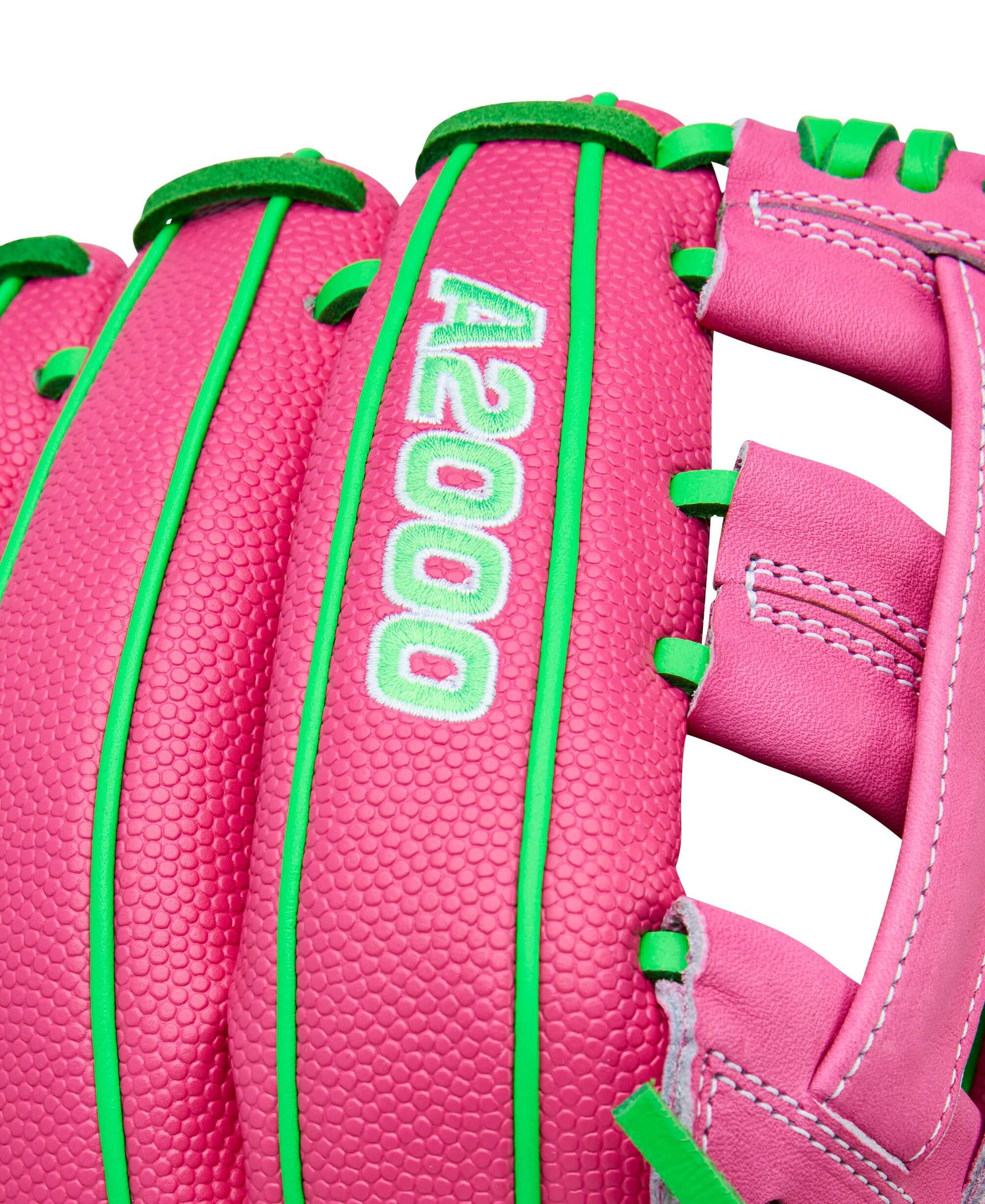 Close-up of Wilson Spring 2026 José Ramírez A2000 JR11 GM 12” Infield Baseball Glove showing pink leather with green lacing and A2000 logo.