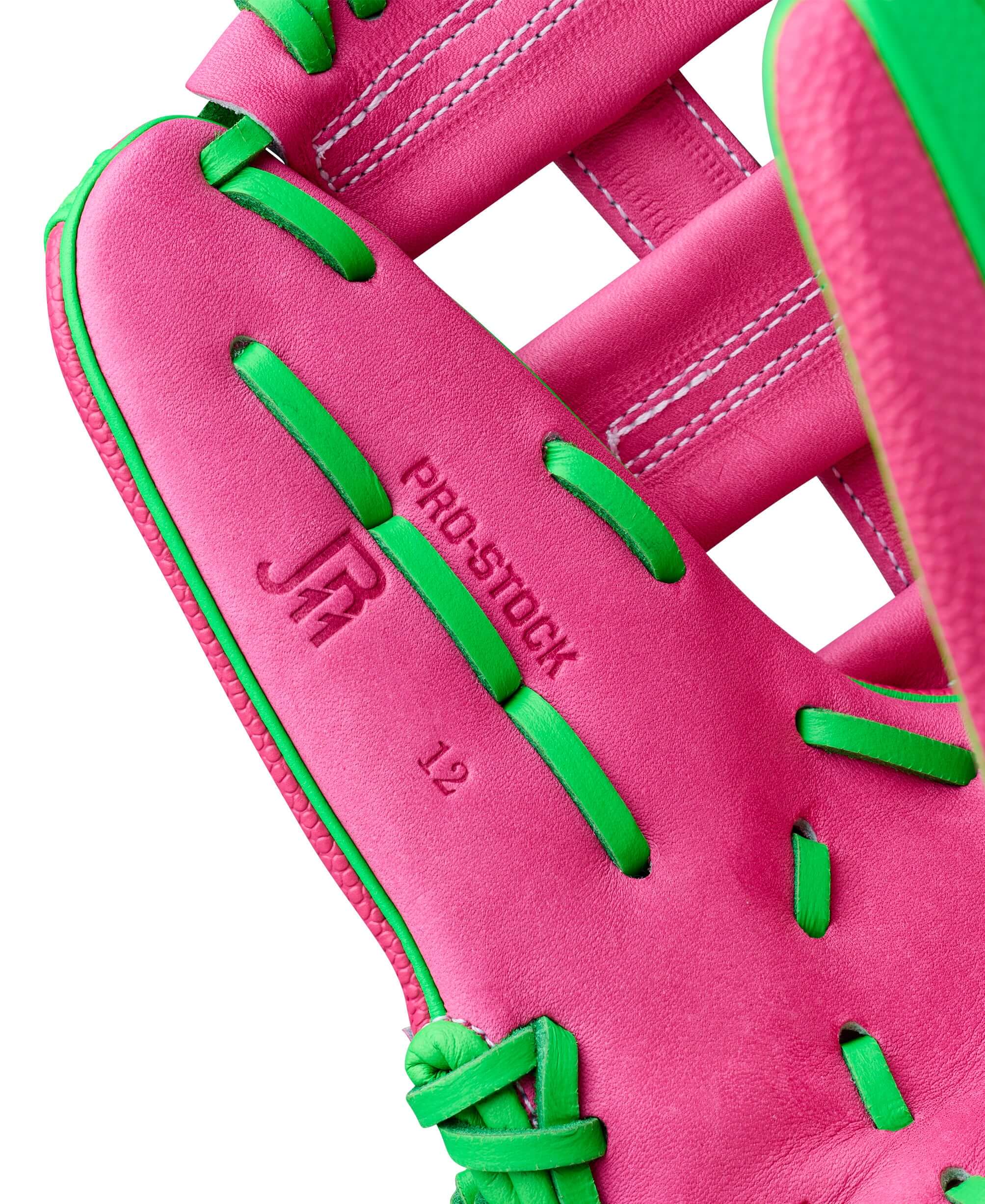 Close-up of Wilson Spring 2026 José Ramírez A2000 JR11 GM 12” Infield Baseball Glove pink leather with green lacing detail.