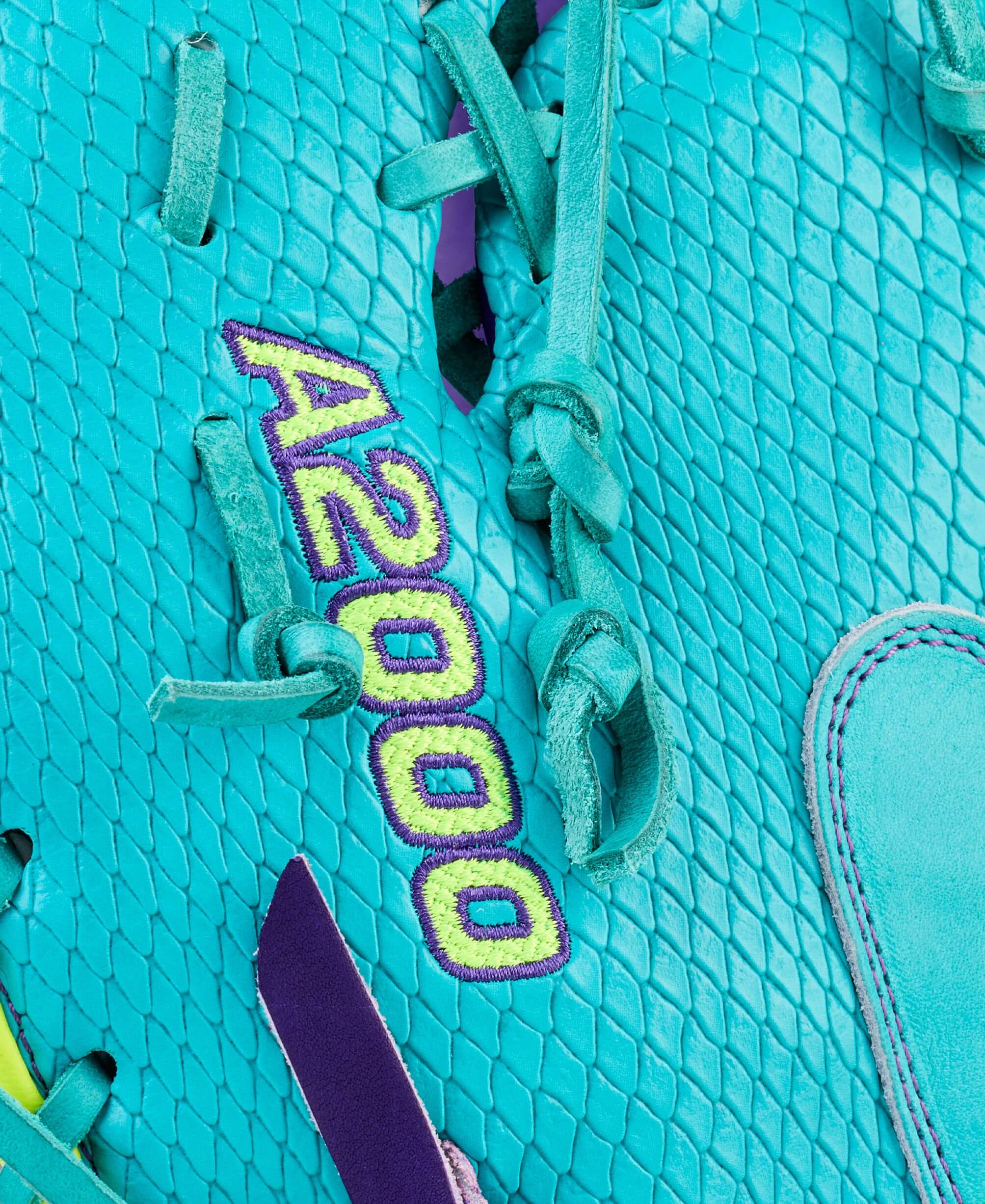 Close-up of turquoise lacing and A2000 embroidery on Wilson Spring 2026 A2000 1612SS 12” Baseball First Base Mitt