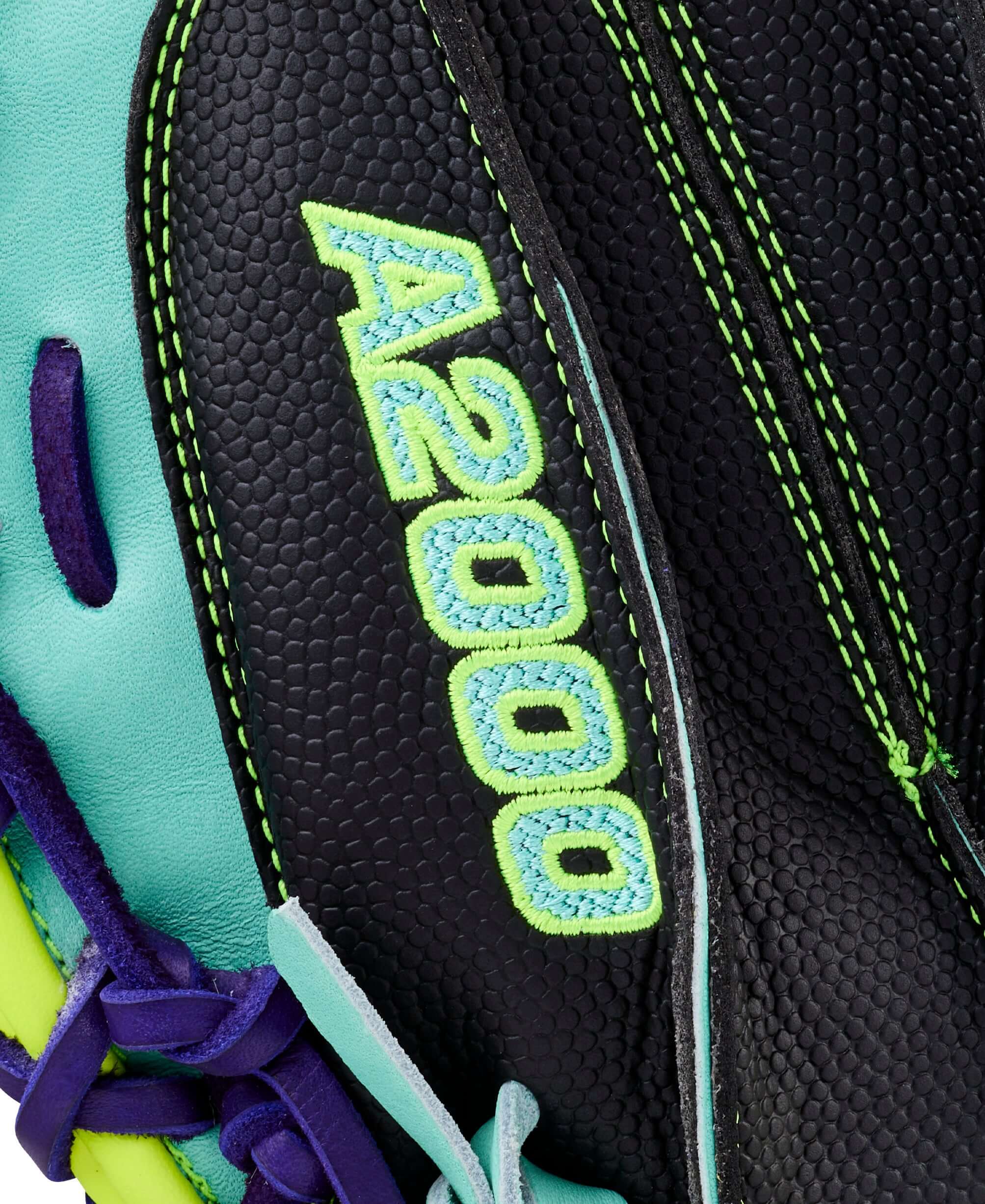 Close-up of Wilson Spring 2026 A2000 PF33SS mitt showing embossed A2000 logo and intricate green stitching on black leather.