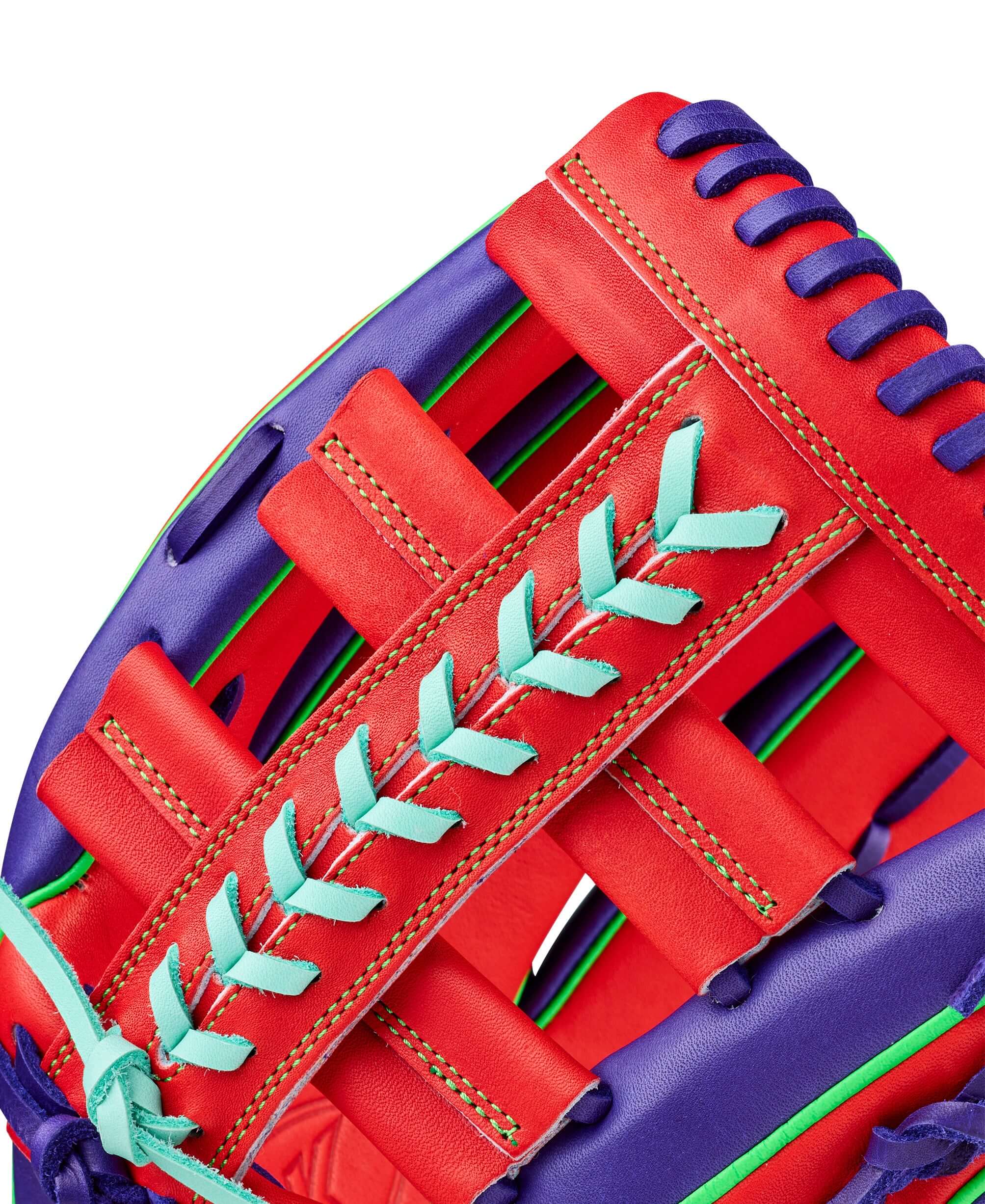Close-up of the web detail on Wilson Spring 2026 A2K 1810 12.75" Outfield Baseball Glove Purple/Red with teal lacing and red leather.