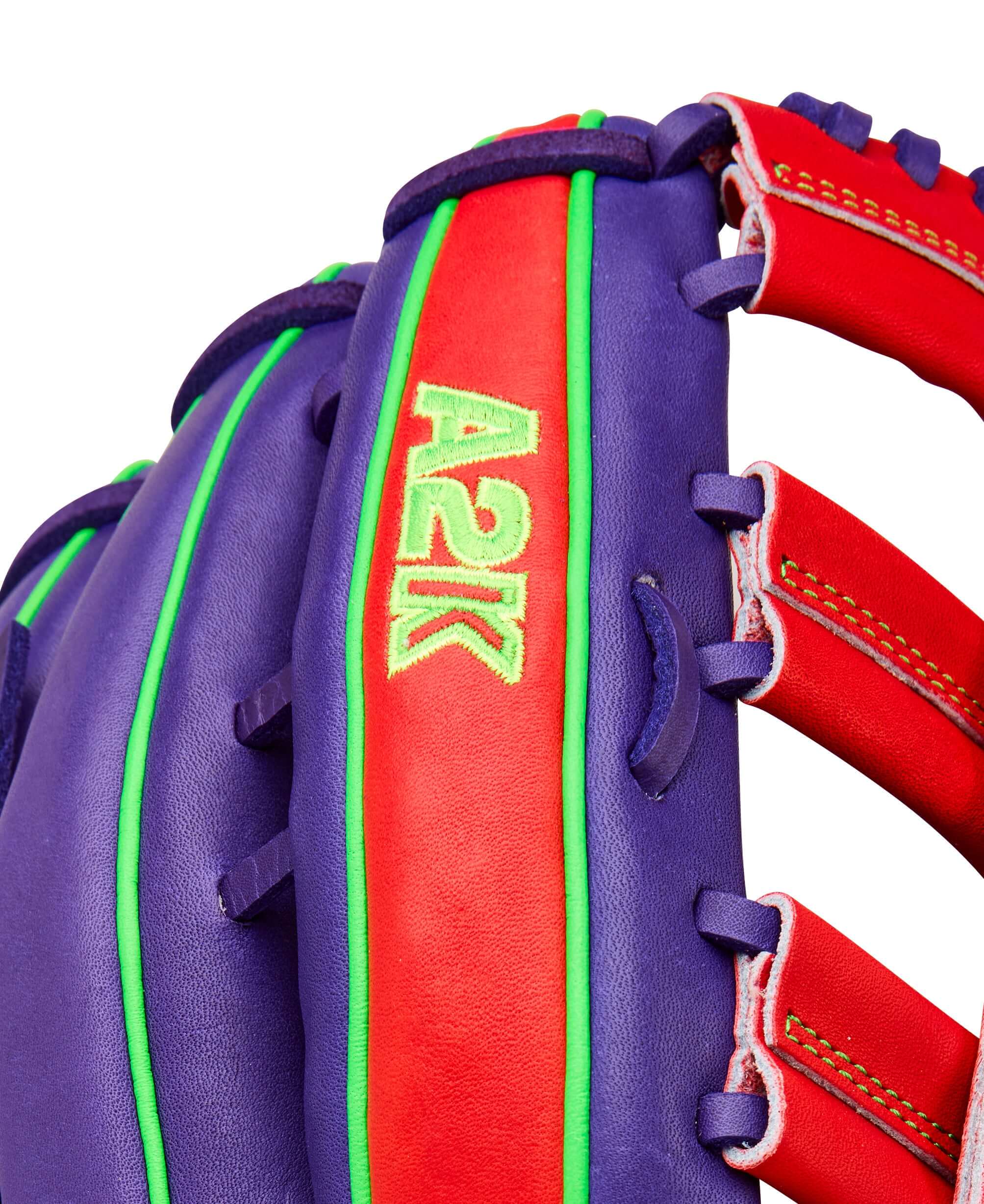 Close-up of Wilson Spring 2026 A2K 1810 12.75" Outfield Baseball Glove showing purple leather, red lacing, and A2K logo.