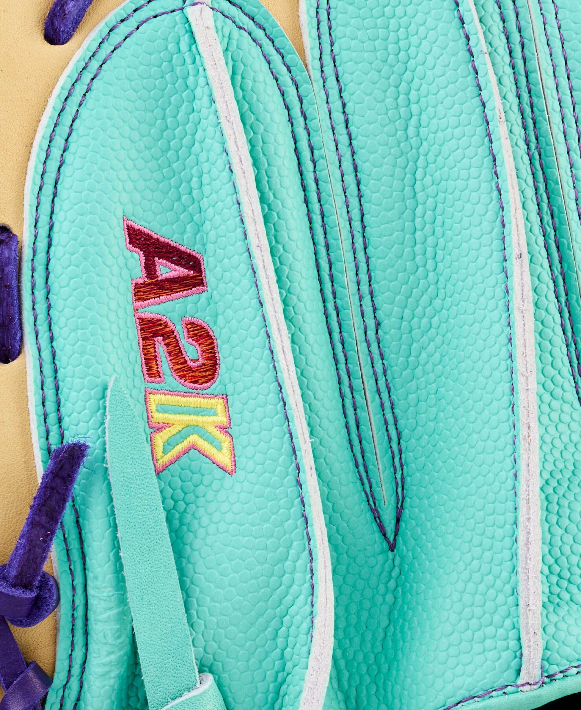Close-up of Wilson Spring 2026 A2K 1734SS 34” Baseball Catcher’s Mitt showing teal leather and purple lacing with A2K logo.
