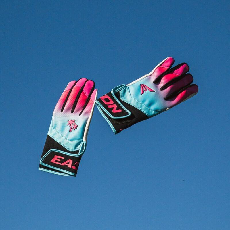 Easton Walk-Off Ethos South Beach Batting Gloves on both hands posed against a blue background.
