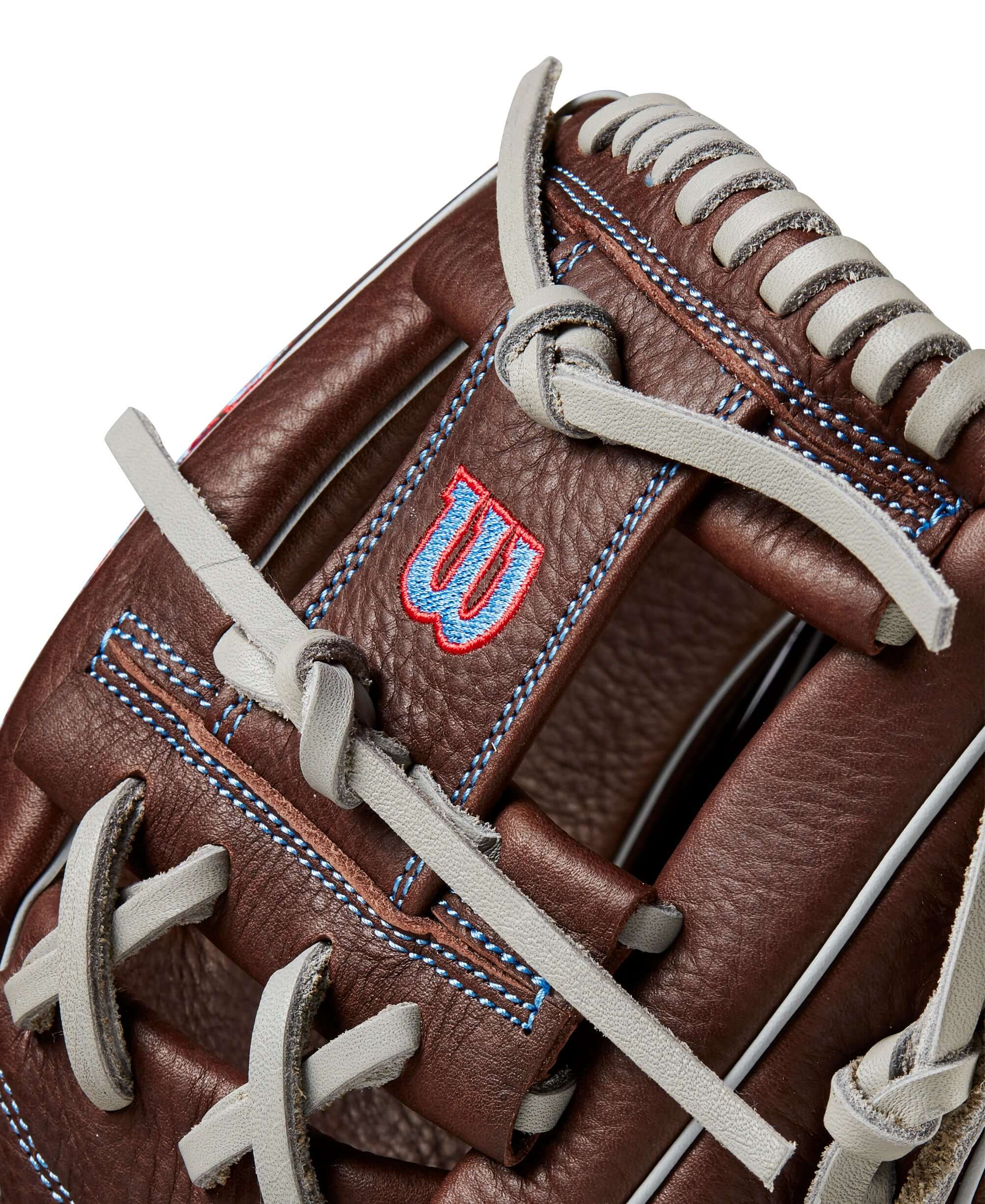 Close-up of Wilson 2024 A1000 1787 infield baseball glove showcasing dark brown leather and red stitching details.
