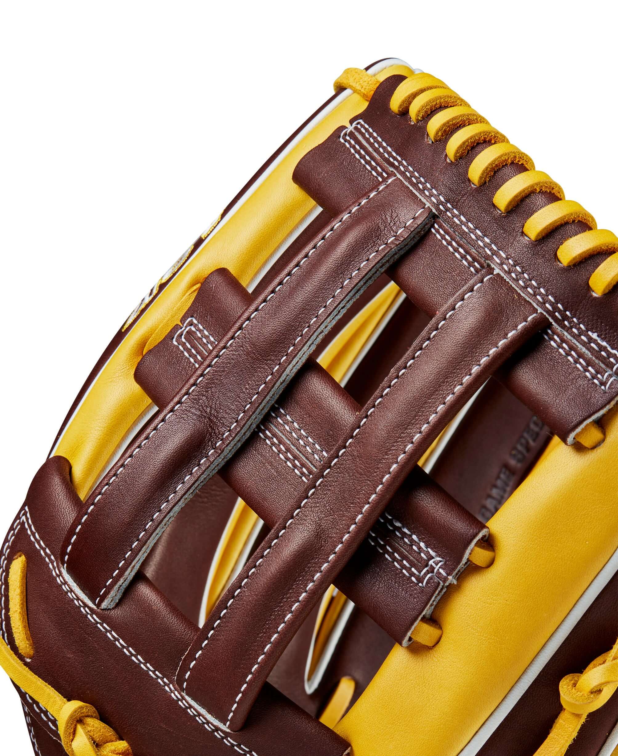 Close-up of the Wilson 2024 A2K Juan Soto baseball glove showcasing the yellow gold and dark brown dual post web design.