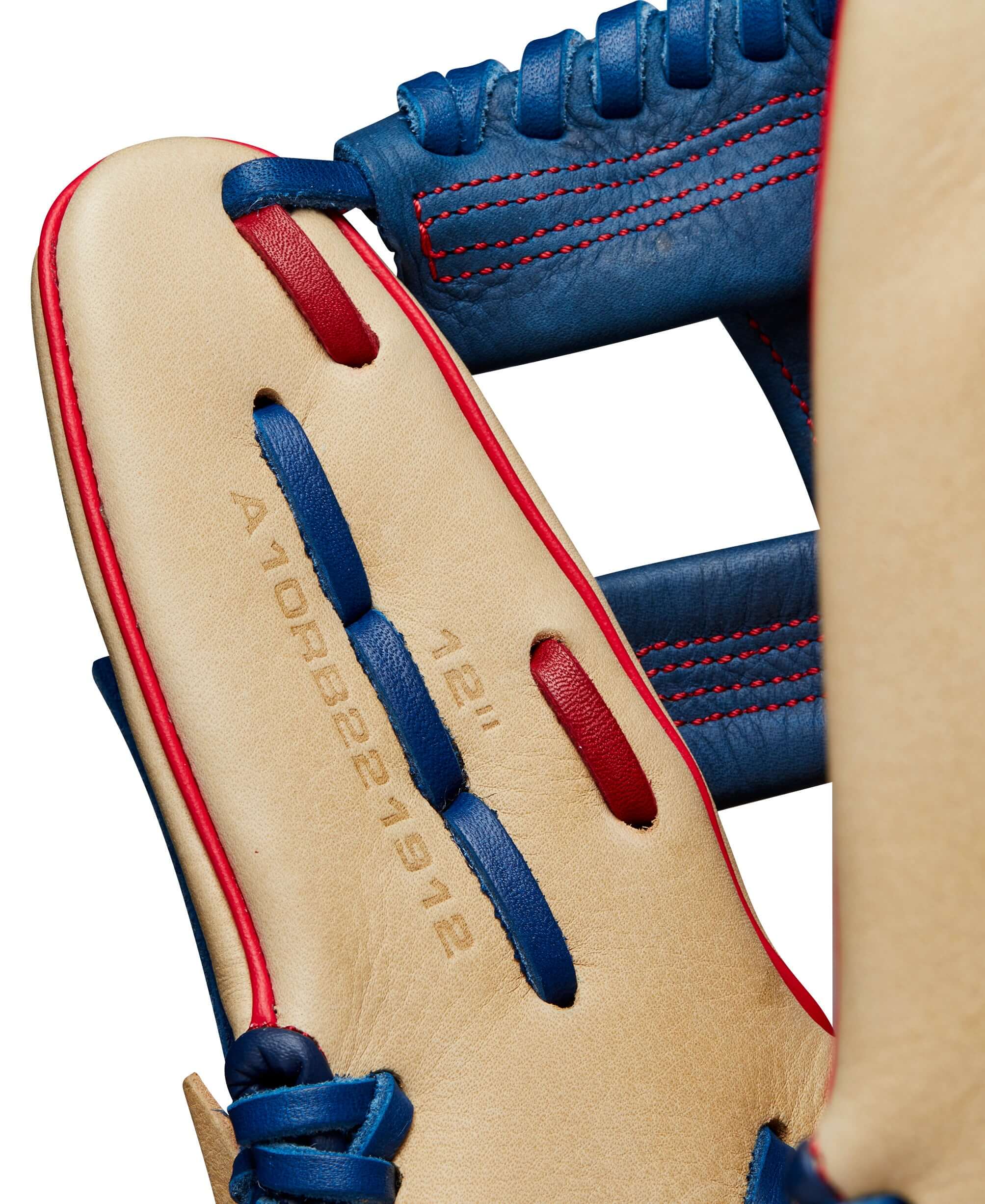 Interior view of Wilson 2024 A1000 1912 infield baseball glove, showcasing blue and tan leather and detailed stitching.
