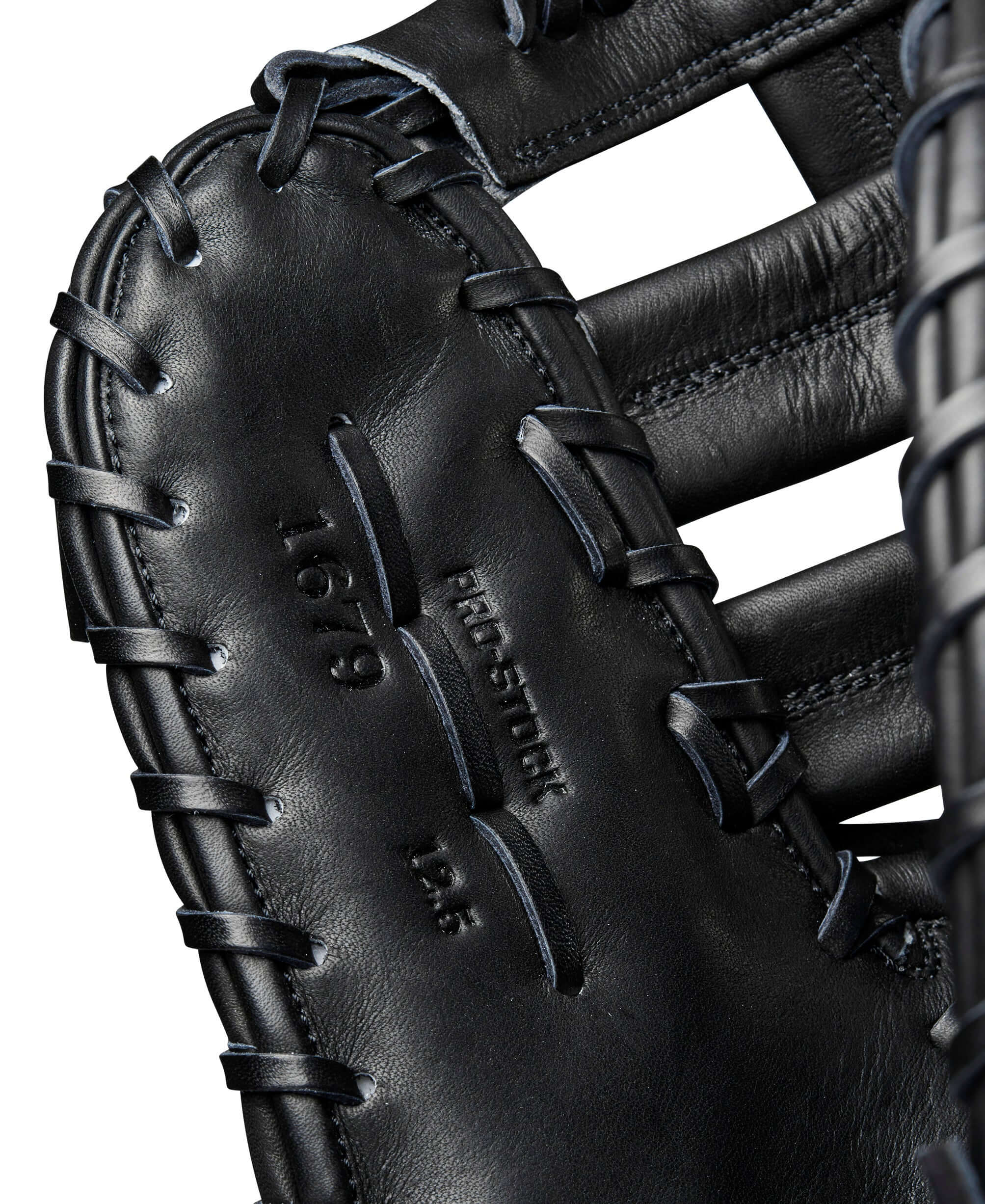 Close-up of Wilson A2000 1679 black first base mitt showcasing leather texture and stitching details.