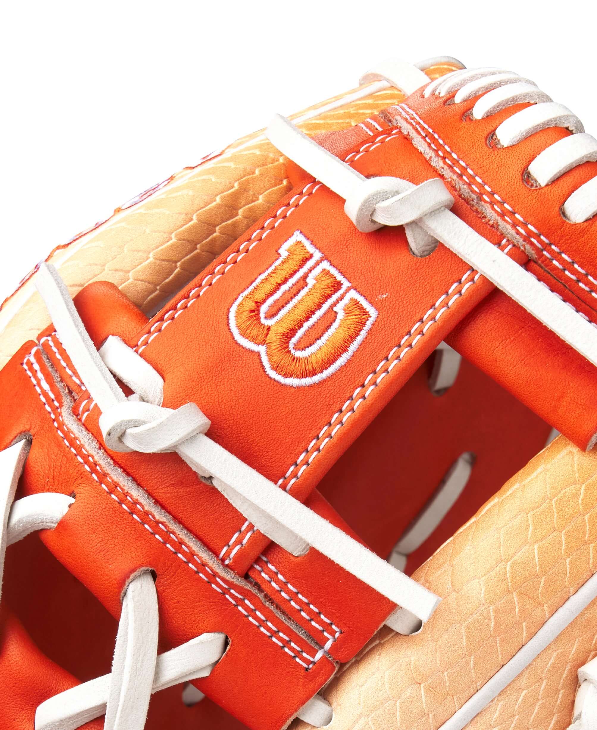 Close-up of Wilson A2000 1975SS glove in vibrant citrus color, showcasing its quality and design details.
