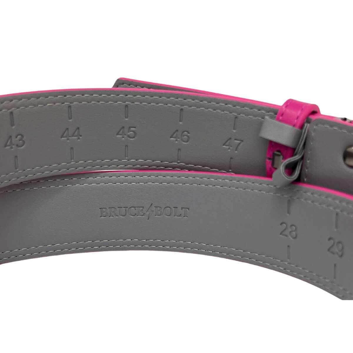 Bruce Bolt Adjustable Belt in Pink showing imprinted length marks for customizable fitting and durable synthetic leather design.