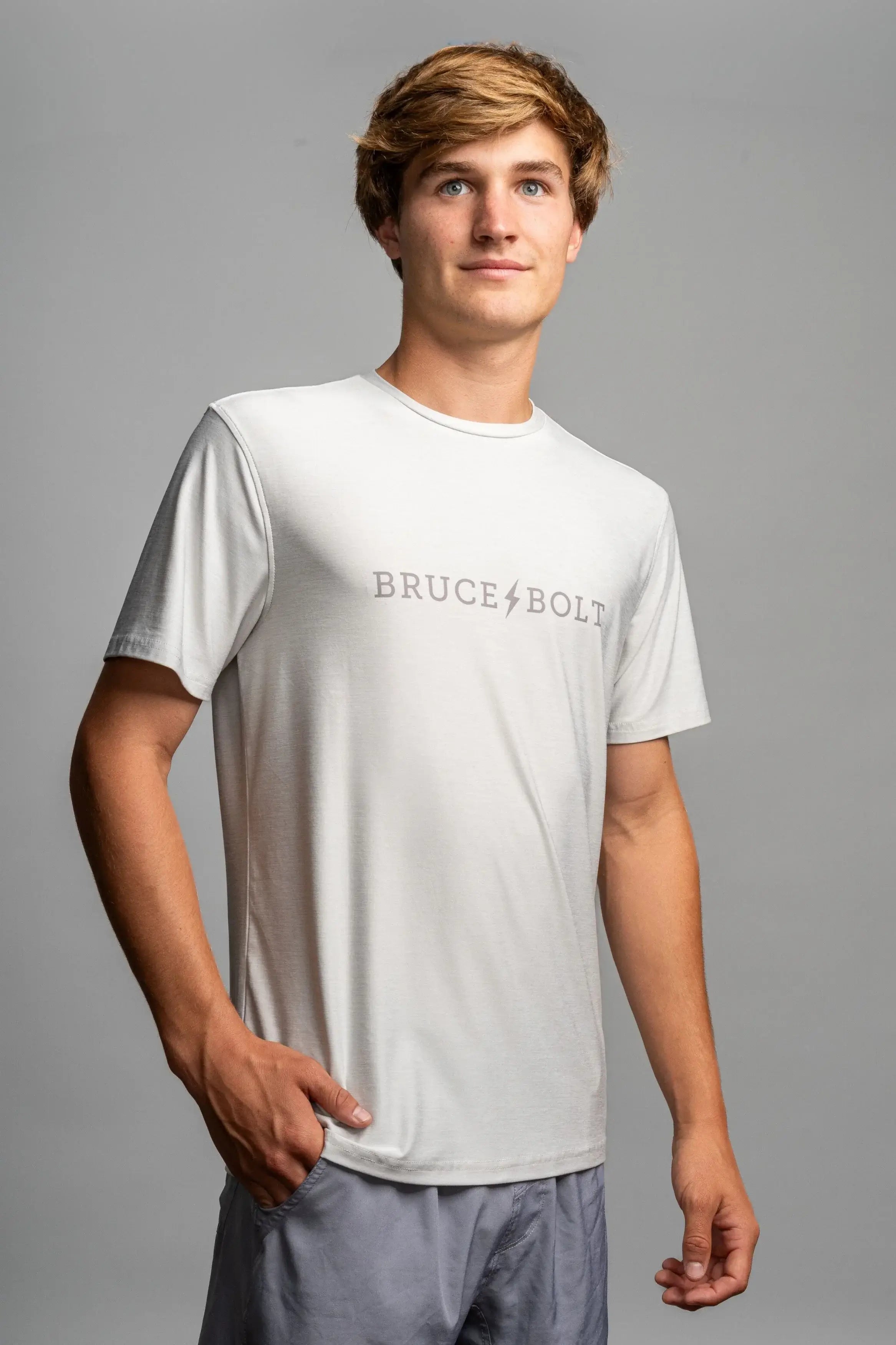 Model wearing a grey Bruce Bolt SuperSoft T-Shirt, showcasing its breathable and stretchy fabric.