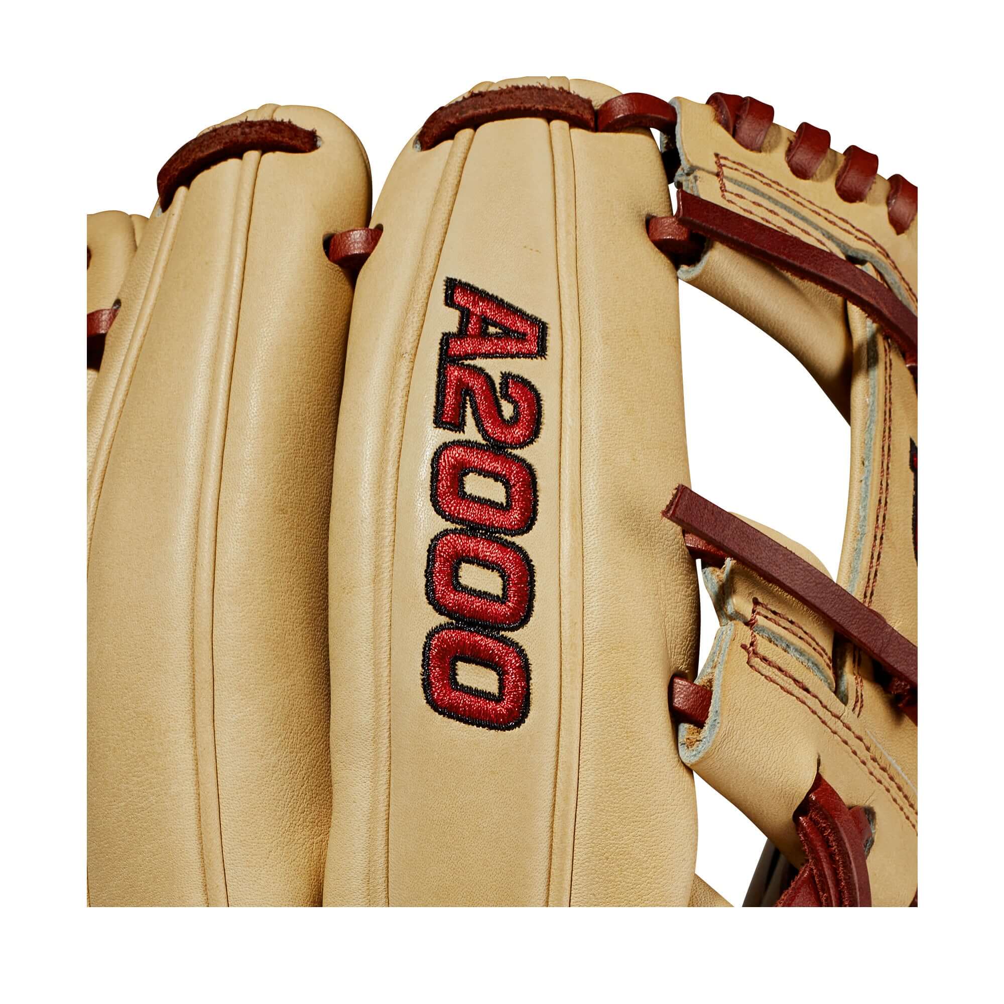 Close-up of Wilson A2000 glove with blonde leather and red stitching, showcasing quality craftsmanship and comfort features.