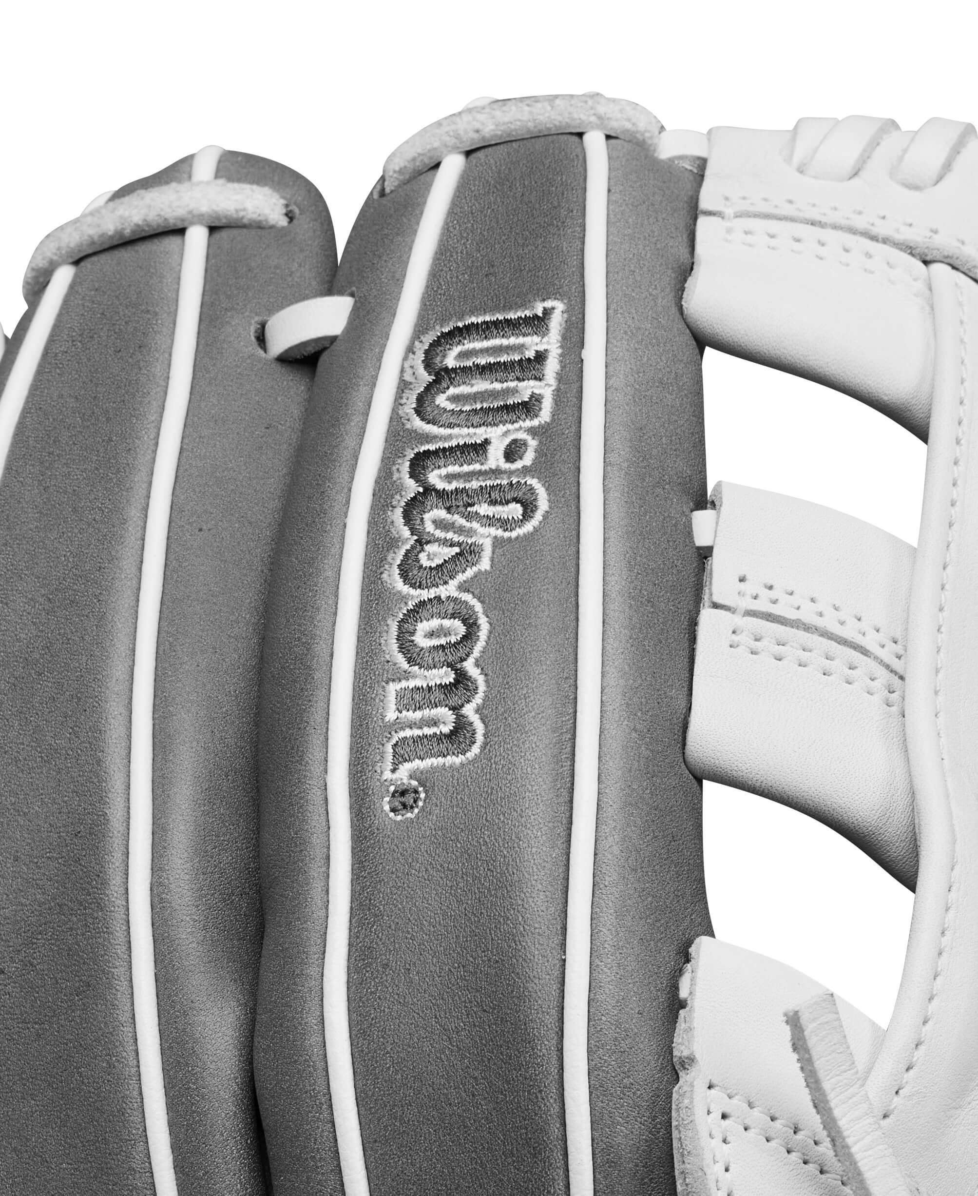 Close-up of Wilson A1000FP IF12 softball glove in grey and white, highlighting brand logo and design features.